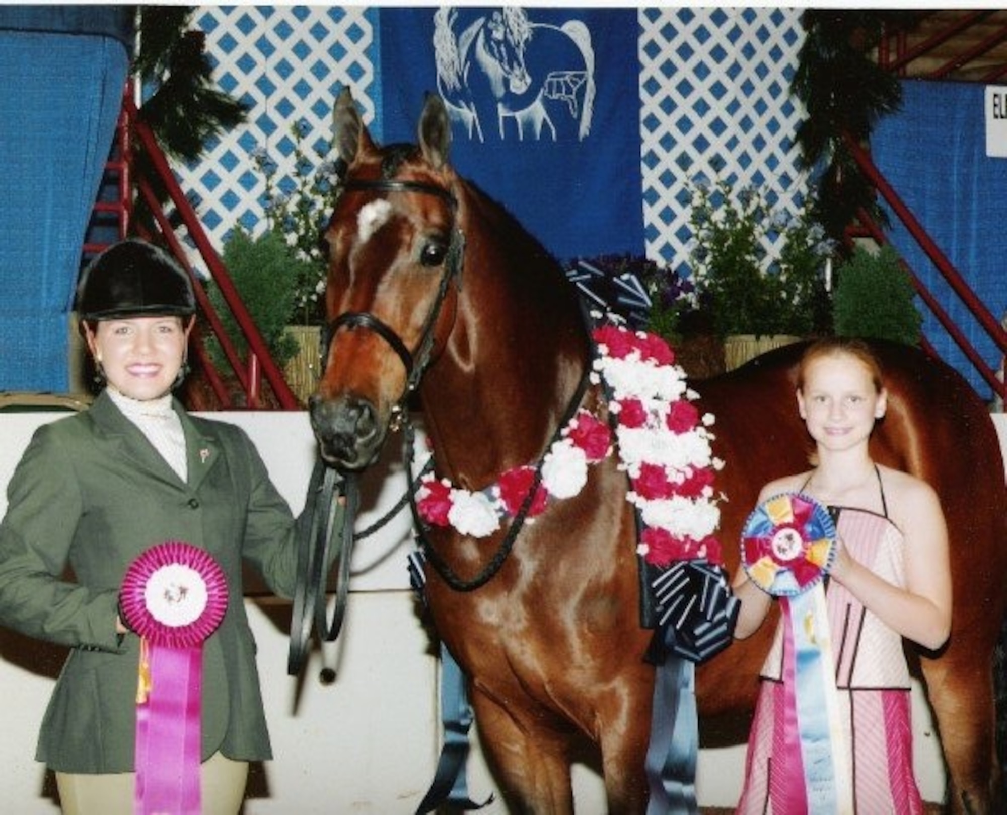 PETERSON AIR FORCE BASE, Colo. – April Dybal, now a crew commander with the 6th Space Warning Squadron at Cape Cod Air Force Station, Mass., stands next to her horse AF Starwalker after winning the Arabian Horse Association Region 12 Showmanship Junior to Handle competition in May 2004. After showing and training horses, Dybal joined the Air Force to continue a family legacy and rejoin the community she grew up with. (Courtesy photo)