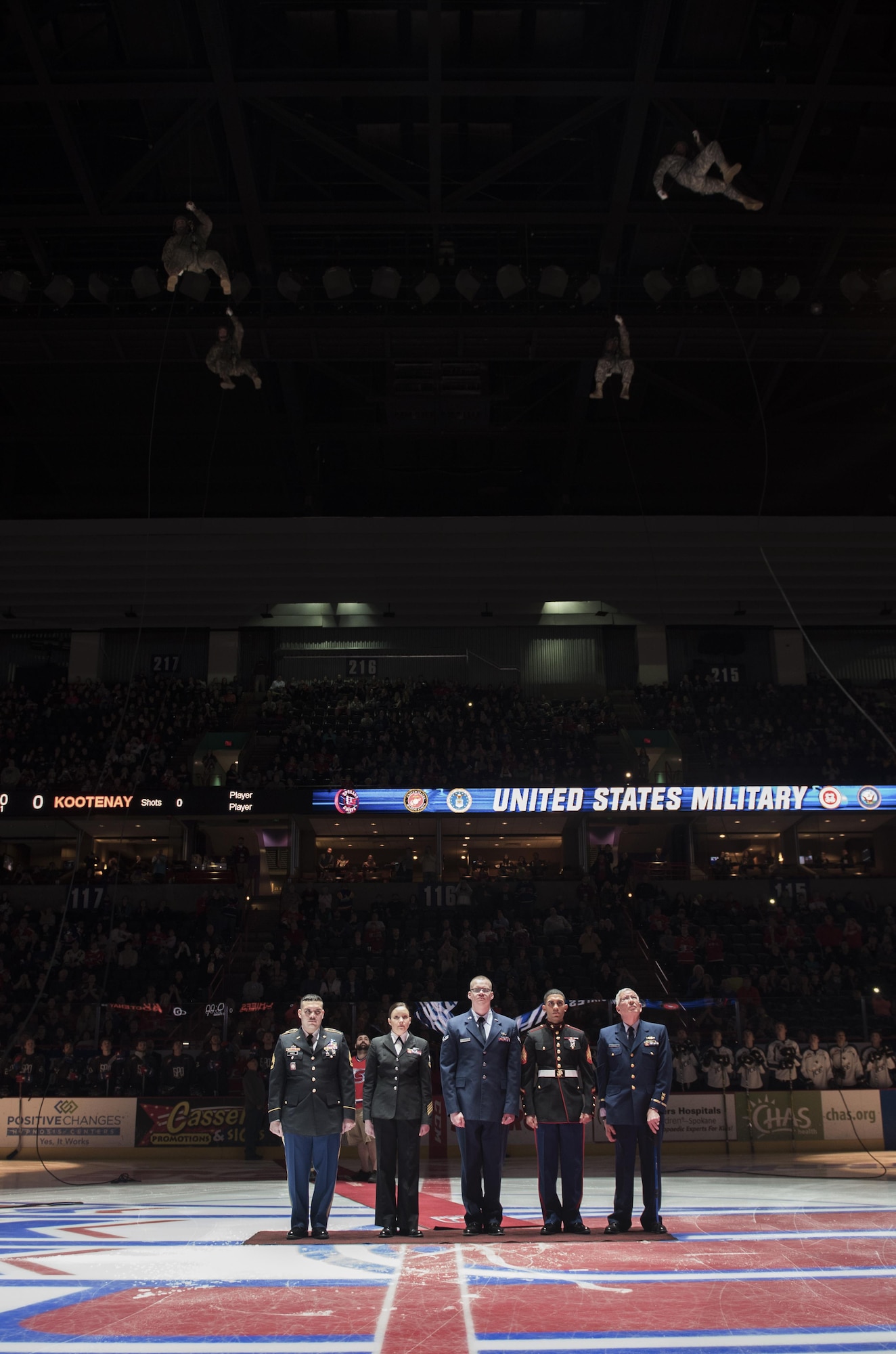 Representatives of all military branches stand at attention while members of the U.S. Army repel from the ceiling before the puck drop during the Spokane Chiefs Military Appreciation Night Jan. 21, 2016, in Spokane, Wash. The Chiefs hold numerous military appreciation nights throughout the season celebrating the veterans who call Spokane home. (U.S. Air Force photo/Airman 1st Class Sean Campbell)