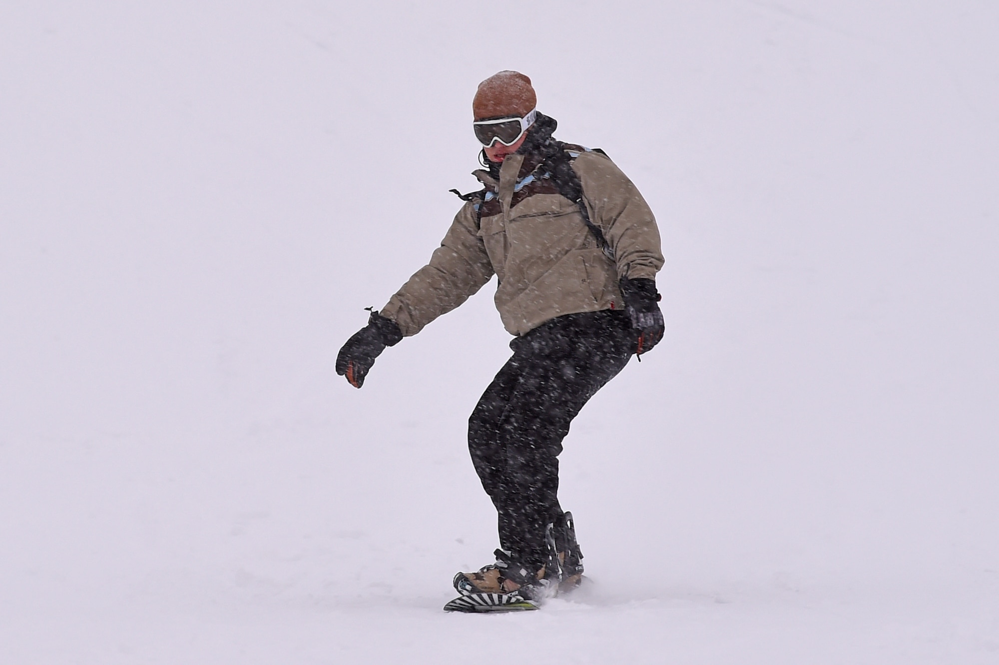 Service members and families snowboard during World Snowboard Day at the Hillberg Ski Area at Joint Base Elmendorf-Richardson, Alaska, Jan. 22, 2017. World Snowboard Day is an opportunity to discover and celebrate snowboarding as sport and culture across the world's summits. The Hillberg Ski Area offers skiing, snowboarding, equipment rentals, lessons and a terrain park. 