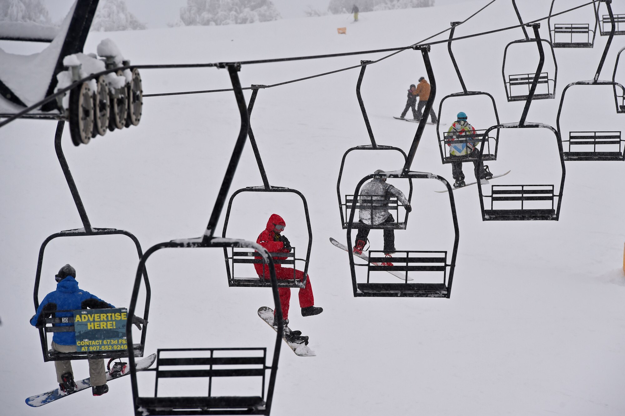 Service members and families snowboard during World Snowboard Day at the Hillberg Ski Area at Joint Base Elmendorf-Richardson, Alaska, Jan. 22, 2017. World Snowboard Day is an opportunity to discover and celebrate snowboarding as sport and culture across the world's summits. The Hillberg Ski Area offers skiing, snowboarding, equipment rentals, lessons and a terrain park. 