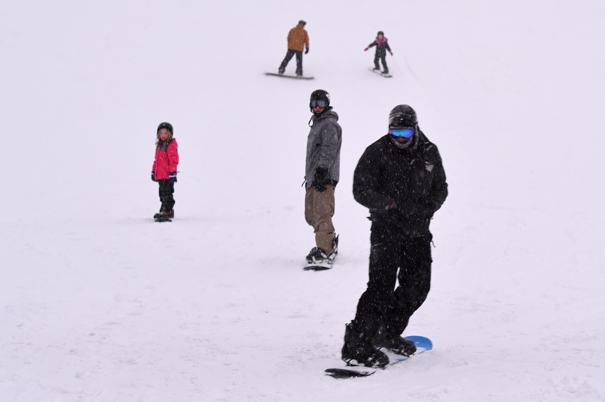 Service members and families snowboard during World Snowboard Day at the Hillberg Ski Area at Joint Base Elmendorf-Richardson, Alaska, Jan. 22, 2017. World Snowboard Day is an opportunity to discover and celebrate snowboarding as sport and culture across the world's summits. The Hillberg Ski Area offers skiing, snowboarding, equipment rentals, lessons and a terrain park. 