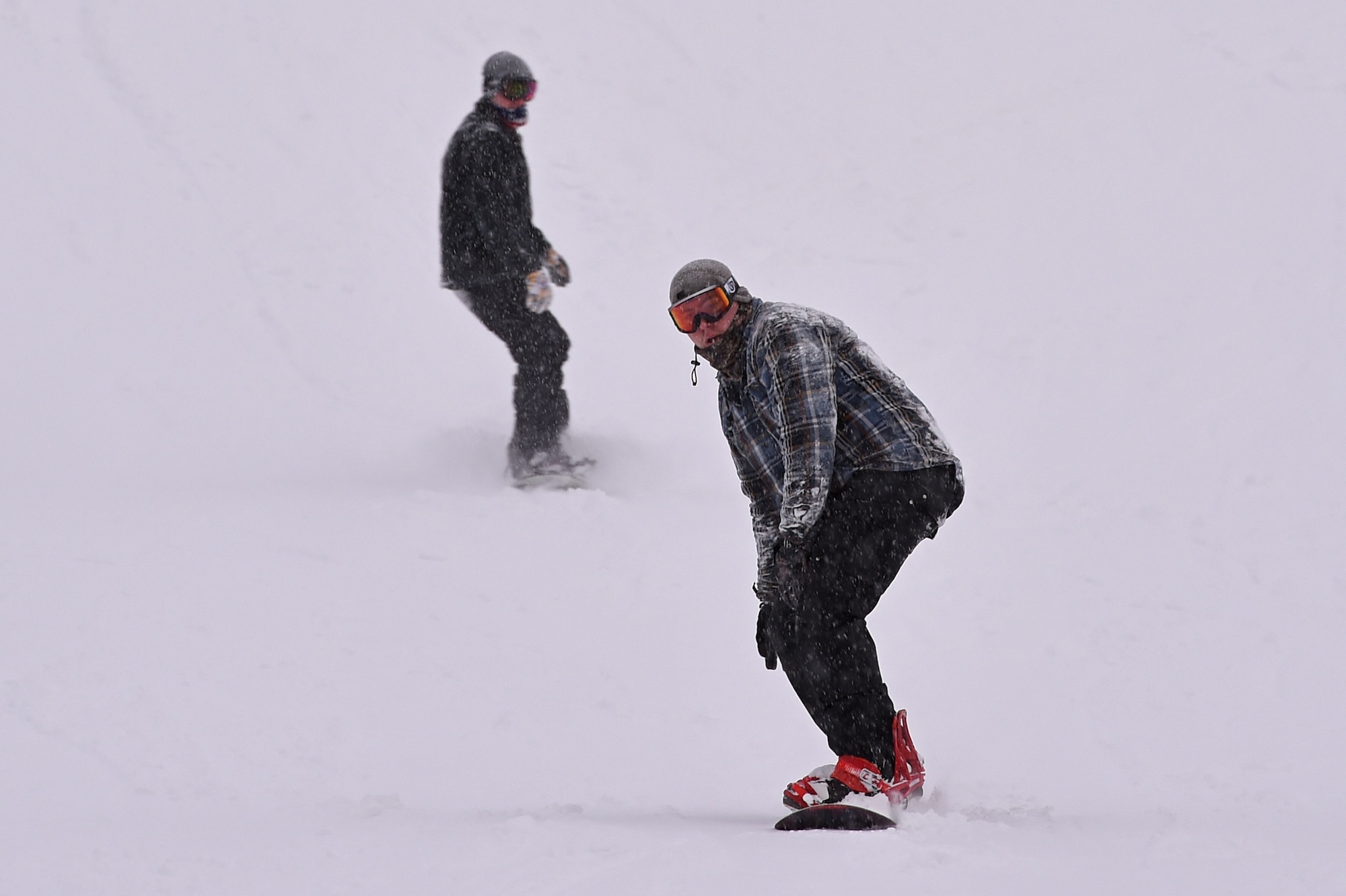 Service members and families snowboard during World Snowboard Day at the Hillberg Ski Area at Joint Base Elmendorf-Richardson, Alaska, Jan. 22, 2017. World Snowboard Day is an opportunity to discover and celebrate snowboarding as sport and culture across the world's summits. The Hillberg Ski Area offers skiing, snowboarding, equipment rentals, lessons and a terrain park. 
