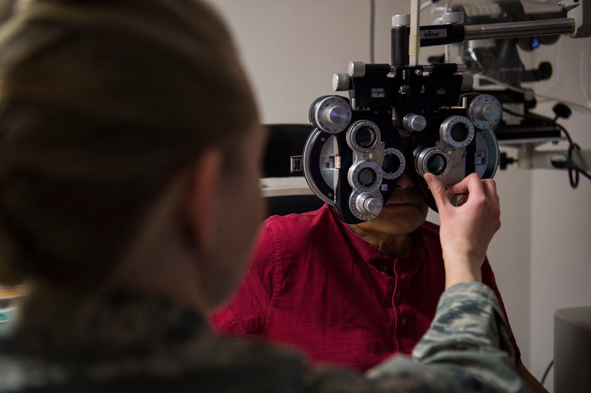 Capt. Page Bosch, Medical Operations Squadron optometrist, performs eye tests on a patient at F.E. Warren Air Force Base, Wyo., Jan. 20, 2017. The Air Force celebrates Biomedical Science Corps Appreciation Week Jan. 23 to 27. The Biomedical Science Corps is comprised of 15 medical AFSCs of which 10 are represented at F.E. Warren. (U.S. Air Force photo by Staff Sgt. Christopher Ruano)