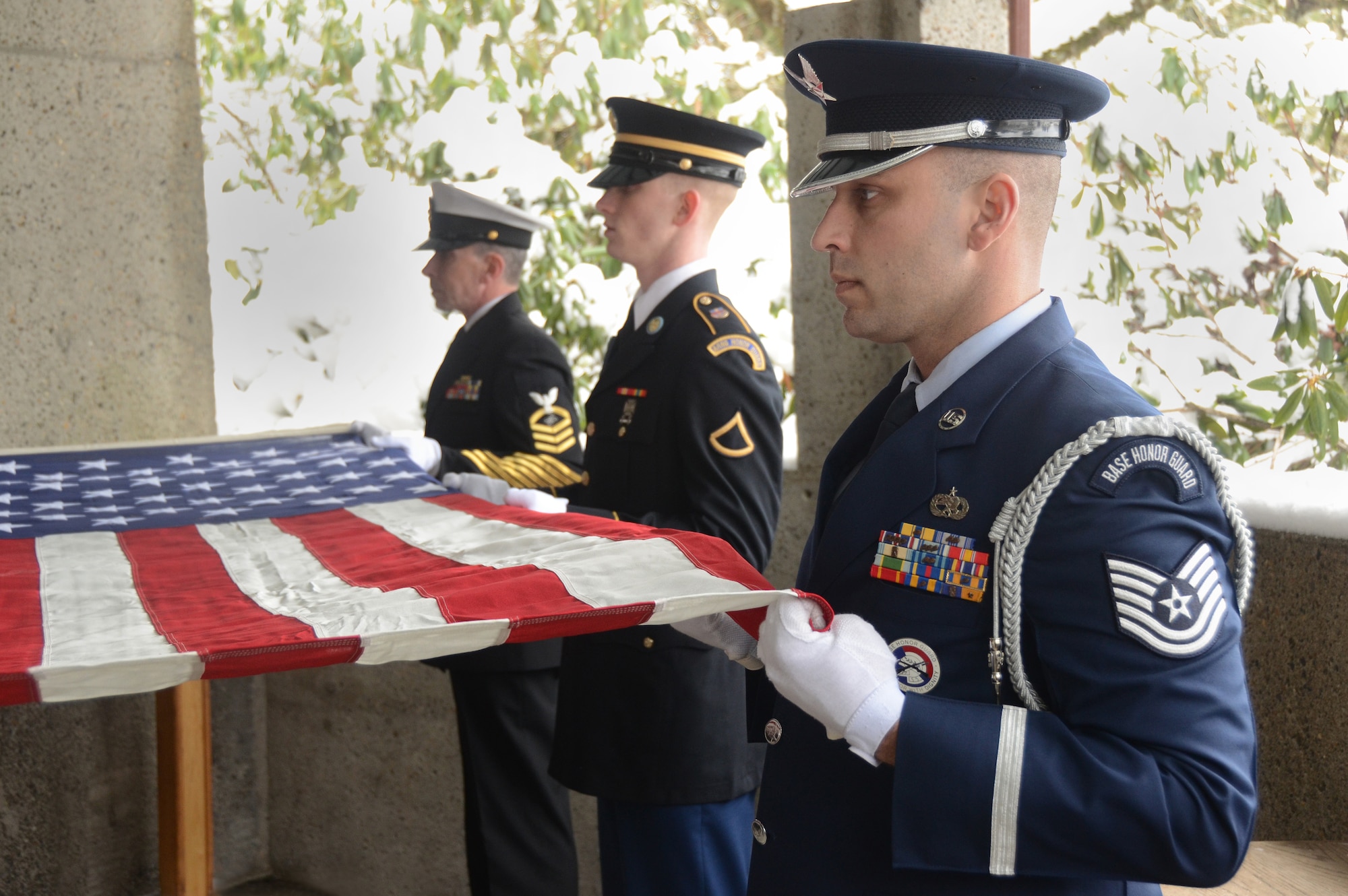 Oregon Air National Guard Tech. Sgt. Justin Meininger, right, along with Army National Guard Private First Class Chris Bourgo, center, and U.S. Navy Electronics Technician Chief Petty Office Jim Cameron, left, perform military funeral honors during a weekly memorial service at Willamette National Cemetery, Portland, Ore., Jan. 13, 2017. (U.S. Air National Guard photo by Tech. Sgt. John Hughel, 142nd Fighter Wing Public Affairs) 