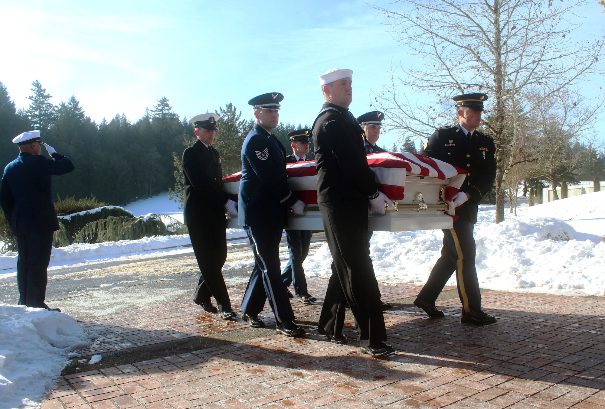 A joint service military funeral honor guard team consisting of U.S. Navy Reservist, and Oregon Army and Air National Guard members work in unison as pallbearers during a U.S. Coast Guard funeral at Willamette National Cemetery, Portland, Ore., Jan. 16, 2017. (Photo courtesy of U.S. Air Force Master Sgt. (ret.) Jonathan Dyer) 