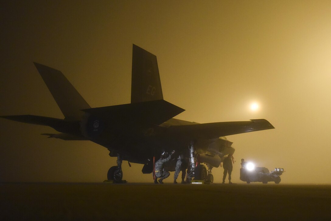 An Air Force weapons crew loads a live GBU-12, a guided laser bomb, into an F-35A at Eglin Air Force Base, Fla., Jan. 18, 2017. Air Force photo by Staff Sgt. Peter Thompson