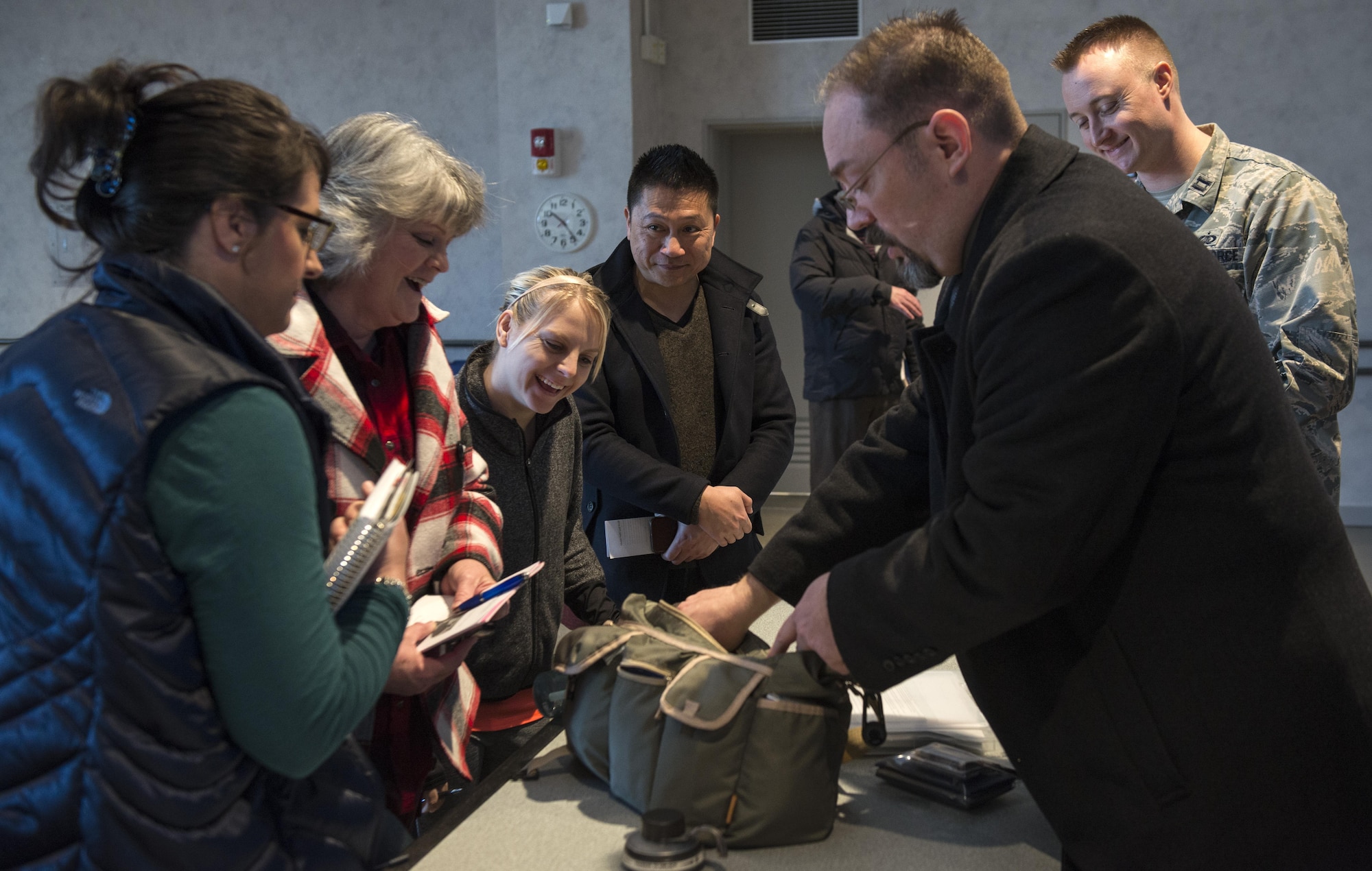 Donald Hoobler, Wing Plans and Programs deputy chief, shows the contents of a Noncombatant Evacuation Operation kit to participants of a NEO Townhall meeting Jan. 23, 2017, at Yokota Air Base, Japan. NEO could occur under a variety of circumstances, including civil unrest, military uprisings, environmental concerns, and natural disasters. (U.S. Air Force Photo by Airman 1st Class Juan Torres)