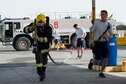 A French Air Force firefighter drags a fire hose during a timed competition at an undisclosed location in Southwest Asia, Jan. 17, 2017.  The 380th Expeditionary Civil Engineering Squadron hosted the event with the intentions of sharpening basic firefighting skills needed during fire and rescue operations. FAF firefighters were invited to continue the developing relationship between the partnered Coalition nations. (U.S. Air Force photo/Senior Airman Tyler Woodward)