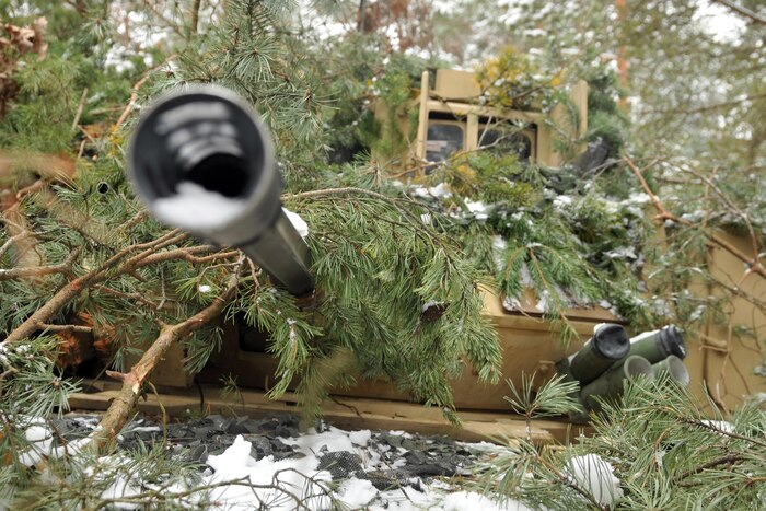 Soldiers assigned to 1st Battalion, 68th Armor Regiment, 3rd Armored Brigade, 4th Infantry Division conceal a Bradley fighting vehicle in wooded terrain at Presidential Range in Swietozow, Poland, Jan. 20, 2017. The soldiers and vehicles are in Poland as part of a nine-month deployment in support of Operation Atlantic Resolve. Army photo by Staff Sgt. Elizabeth Tarr