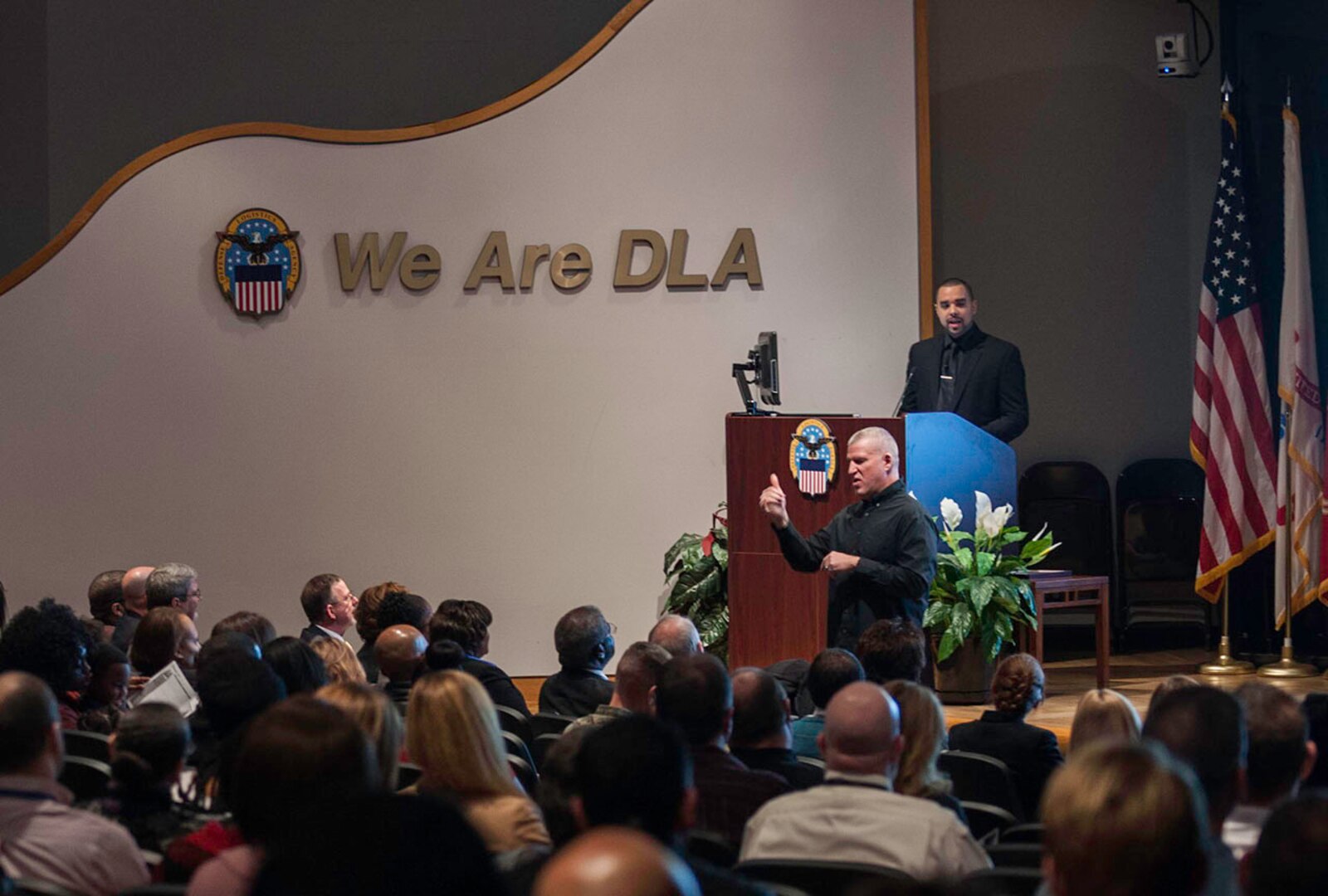 Pastor John T. Boston, II speaks to an audience of Defense Federal Community members inside the Defense Supply Center Columbus Operations Center auditorium during the installation's annual Dr. Martin Luther King Jr. observance ceremony. The Jan. 19 event also included music and dance performances.