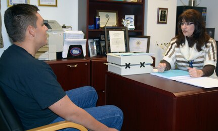 Petra Allen, a Waivers clerk assigned to Navy Recruiting District (NRD) San Antonio speaks with future Sailor Antonio Diaz of Belton, Texas, regarding the approval of his waiver to enlist in the U.S. Navy. Allen, a native of Erlangen, Germany, was recognized as the NRD's contractor of the year for Fiscal Year 2016.
