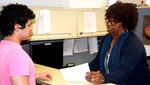 Mariel Grimes, an enlisted processing assistant assigned to Navy Recruiting District (or NRD) San Antonio speaks with future Sailor Antonio Victor Lara of McAllen, Texas, regarding his in-processing for enlistment into the U.S. Navy. Grimes, a native of St. Thomas, U.S. Virgin Islands was recognized as the NRD's Civilian of the Year for Fiscal Year 2016.