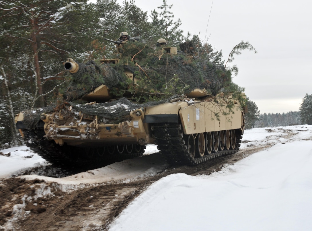 An M1 Abrams tank emerges out of wooded terrain after soldiers assigned to the 4th Infantry Division’s 1st Battalion, 68th Armor Regiment, 3rd Armored Brigade Combat Team had concealed it to blend in with the surrounding environment at Presidential Range in Swietozow, Poland, Jan. 20, 2017. The vehicles and soldiers are part of a nine-month deployment in support of Operation Atlantic Resolve. Army photo by Staff Sgt. Elizabeth Tarr