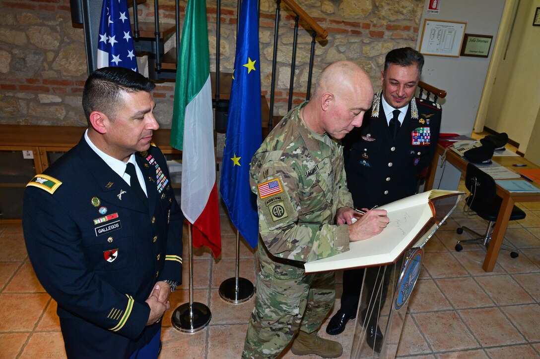 U.S. Army Col. Darius S. Gallegos (left), Center of Excellence for Stability Police Units (CoESPU) deputy director and Brig. Gen. Giovanni Pietro Barbano , (CoESPU) director, look Lt. Gen. Charles D. Luckey (center), Commanding General U.S. Army Reserve Command, sign the guestbook, during visit at Center of Excellence for Stability Police Units (CoESPU) Vicenza, Italy, January 20, 2017.(U.S. Army Photo by Visual Information Specialist Paolo Bovo/released)
