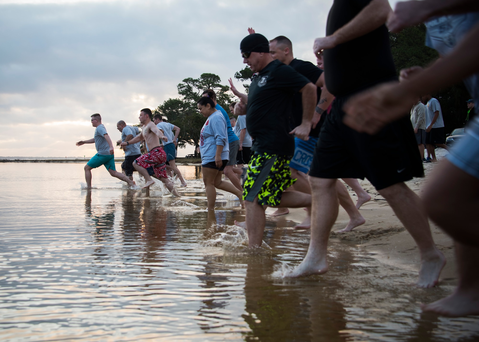 Airmen dash into the Choctawatchee Bay during the 7th annual Polar Bear Plunge Jan. 20 at Post’l Point at Eglin Air Force Base, Fla. More than 50 people came out for the PBP during a Florida, winter morning with a temperature of 65 degrees. (U.S. Air Force photo/Ilka Cole) 