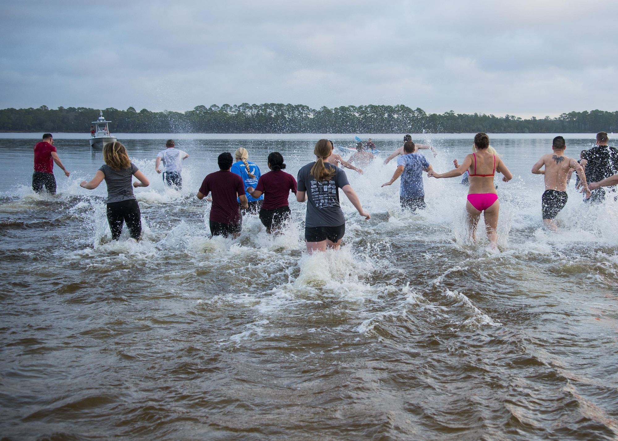 More than 50 people run into the Choctawatchee Bay during the 7th annual Polar Bear Plunge Jan. 20 at Post’l Point at Eglin Air Force Base, Fla. Runners took the PBP during a Florida, winter morning with a temperature of 65 degrees. (U.S. Air Force photo/Ilka Cole) 