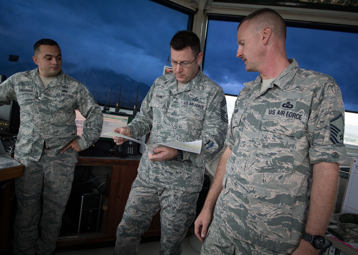 Chief Master Sgt. Scott Sojak, Air Combat Command Air Traffic Control functional manager, reviews an example of a flight schedule at the Soto Cano Airfield Control Tower, Jan. 18. Sojak was part of a Staff Assistance Visit team who conducted an airfield compliance assessment at Soto Cano Air Base, Honduras, Jan. 17-20.