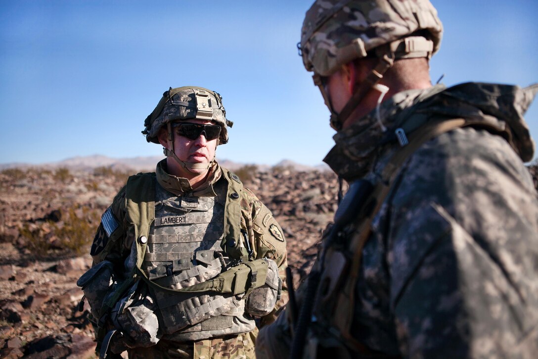 Army Col. Kevin Lambert, left, discusses a force-on-force battle with a staff member during training exercise 17-03 at the National Training Center, Fort Irwin, Ca., Jan. 16, 2017. Lambert is, commander, 25th Infantry Division’s 1st Stryker Brigade Combat Team. Army photo by Sgt. Jason A. Young