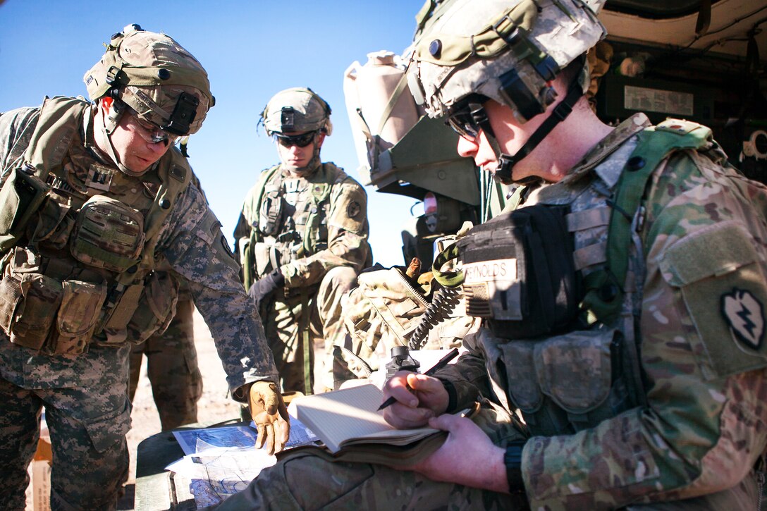 Army 1st Lt. Michael Reynolds, right, and Army Capt. Nicholas Runyon discuss the situation during training exercise 17-03 at the National Training Center, Fort Irwin, Ca., Jan. 16, 2017. Reynolds is assigned to the 25th Infantry Division’s Company B, 3rd Battalion, 21st Infantry Regiment, 1st Stryker Brigade Combat Team. Runyon is commander, 25th Infantry Division’s Company B, 3rd Battalion, 21st Infantry Regiment, 1st Stryker Brigade Combat Team.