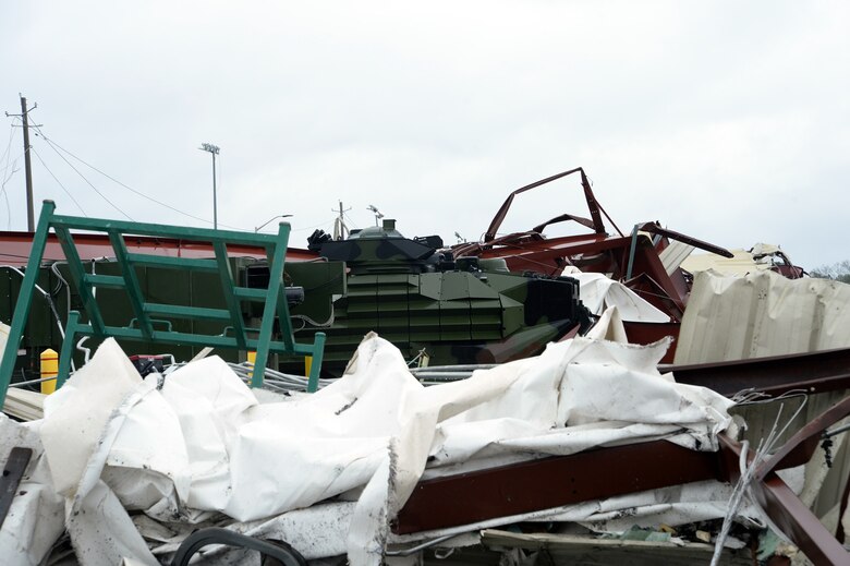 An assault amphibious vehicle stands alone in the rubble of a damaged warehouse destroyed by a tornado that struck Marine Corps Logistics Base Albany, Jan. 23, 2017. A line of strong thunderstorms produced a tornado that passed through the Albany, Georgia community and Marine Corps Logistics Base Albany carving a path of destruction leaving the landscape strewn with broken trees, downed power lines and damaged structures, Jan. 22, 2017.