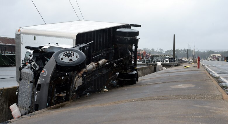A 3-ton government vehicle is overturned in a drainage ditch following the impact of a tornado on Marine Corps Logistics Base Albany, Jan. 23, 2017. A line of strong thunderstorms produced a tornado that passed through the Albany, Georgia community and Marine Corps Logistics Base Albany carving a path of destruction leaving the landscape strewn with broken trees, downed power lines and damaged structures, Jan. 22, 2017.