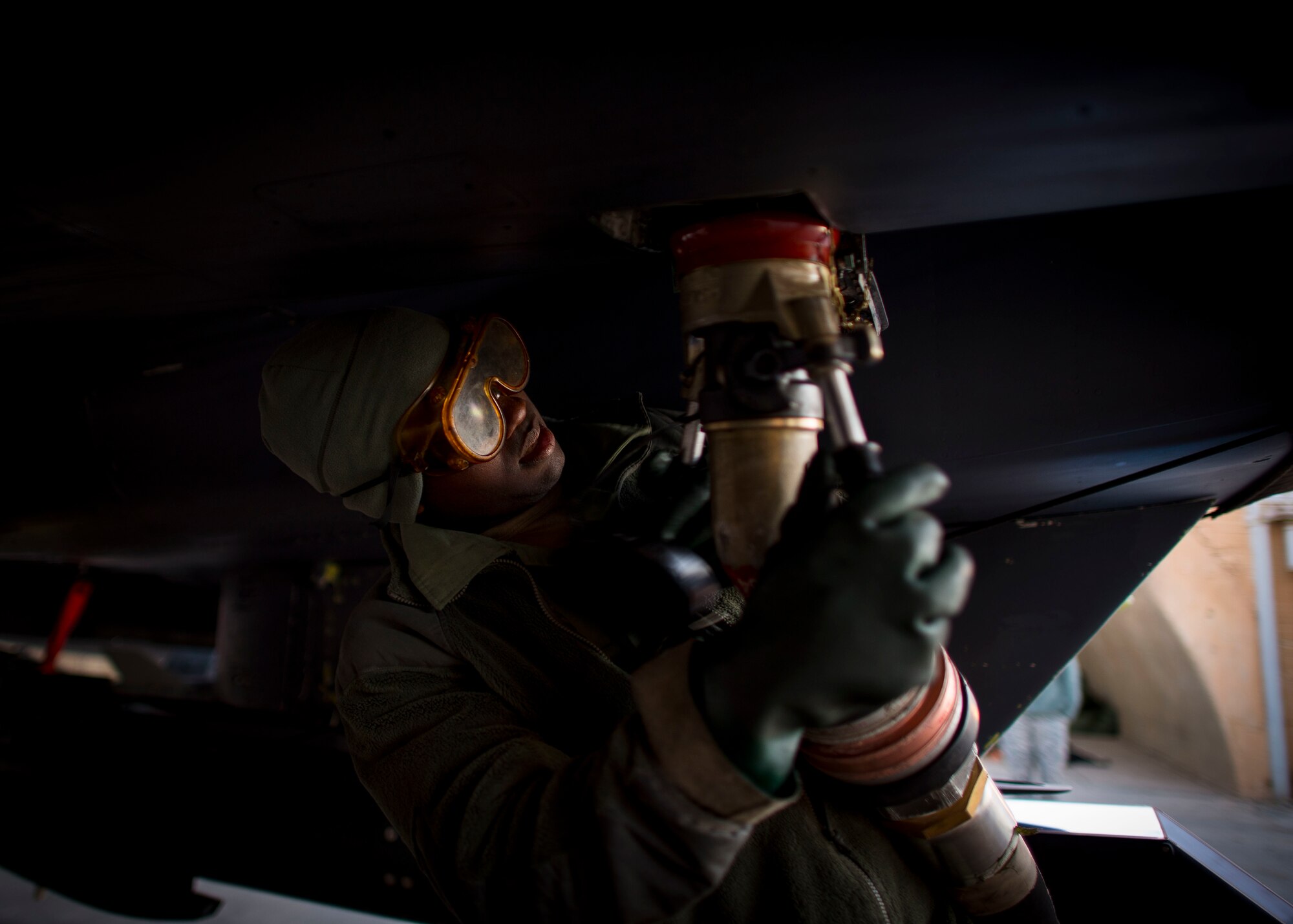 Senior Airman Travon Taylor, 332nd Expeditionary Maintenance Squadron crew chief, connects a fuel hose to an F-15E Strike Eagle, Jan. 9, 2017, in Southwest Asia. The 332nd EMXS crew chiefs are in charge of maintenance concerning the aircraft. (U.S. Air Force photo by Staff Sgt. Eboni Reams)