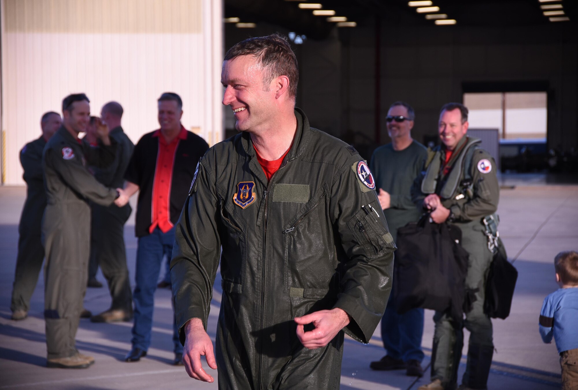 Col. Stephen Nelson smiles after his family members spray him down with water at the conclusion of his final flight as 301st Operations Group commander, Jan. 20, 2017 at Naval Air Station Fort Worth Joint Reserve Base, Texas. Col. Nelson has served for more than 13 years in various positions within the 301st Fighter Wing, including the 457th Fighter Squadron. (U.S. Air Force photo by Staff Sgt. Samantha Mathison)
