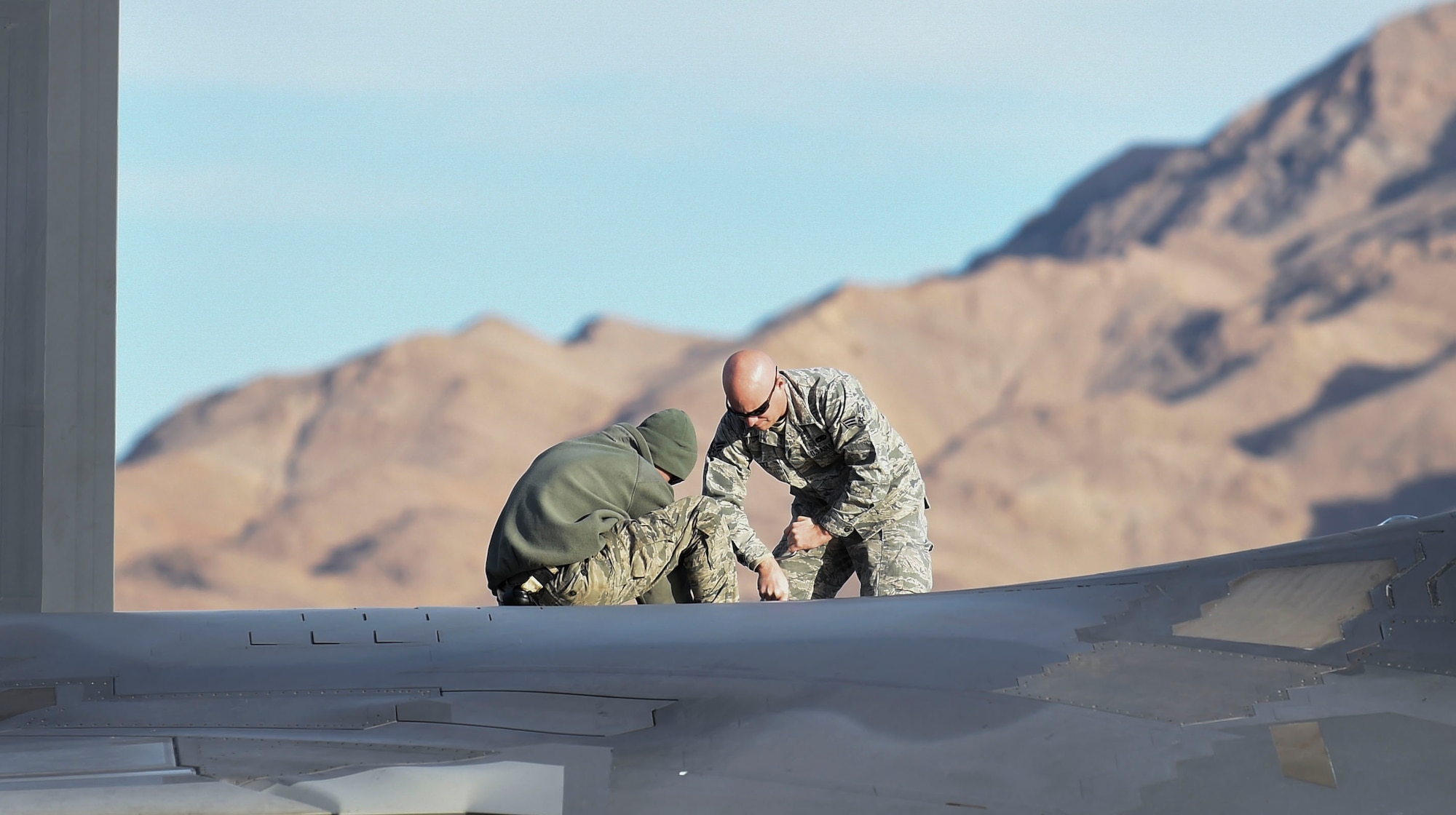 U.S. Air Force Airmen with the 1st Aircraft Maintenance Squadron conduct maintenance checks on an F-22 Raptors from the 1st Fighter Wing participating in Red Flag 17-1 at Nellis Air Force Base, Nev., Feb. 18, 2017. Raptor teams started participating in Red Flag in 2007 and have since proven themselves as a critical component of both air-to-air and air-to-ground missions. (U.S. Air Force photo by Staff Sgt. Natasha Stannard)