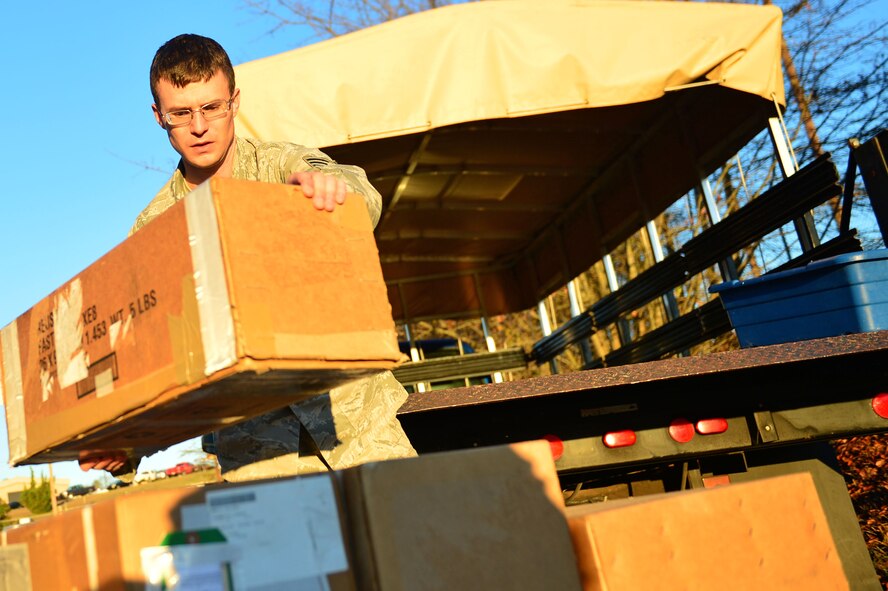 U.S. Air Force Senior Airman William Sams, 20th Logistics Readiness Squadron flight service center journeyman, lifts a package during a shipment delivery at Shaw Air Force Base, S.C., Jan. 24, 2017. Airmen assigned to the 20th LRS FSC deliver numerous packages to the 20th LRS inbound and outbound cargo facility for shipment. (U.S. Air Force photo by Airman 1st Class Christopher Maldonado)