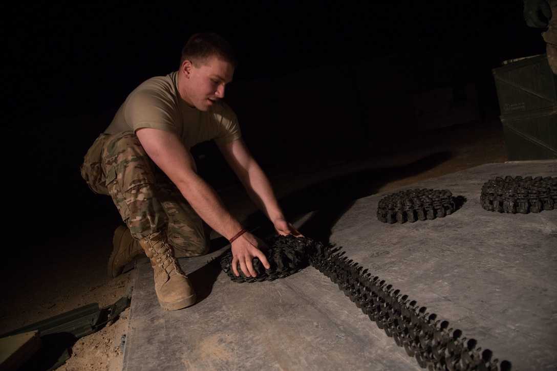 Army Spc. Ivan Celley rolls an ammunition belt for a land–based Phalanx weapon system at Camp Manion, Iraq, Jan 7, 2017. Celley is assigned to Bravo Battery, 5th Battalion, 5th Air Defense Artillery Regiment, The Phalanx is a rapid-fire, computer-controlled, radar-guided gun system designed to defeat anti-ship missiles and other close-in air and surface threats. Army photo by Spc. Christopher Brecht