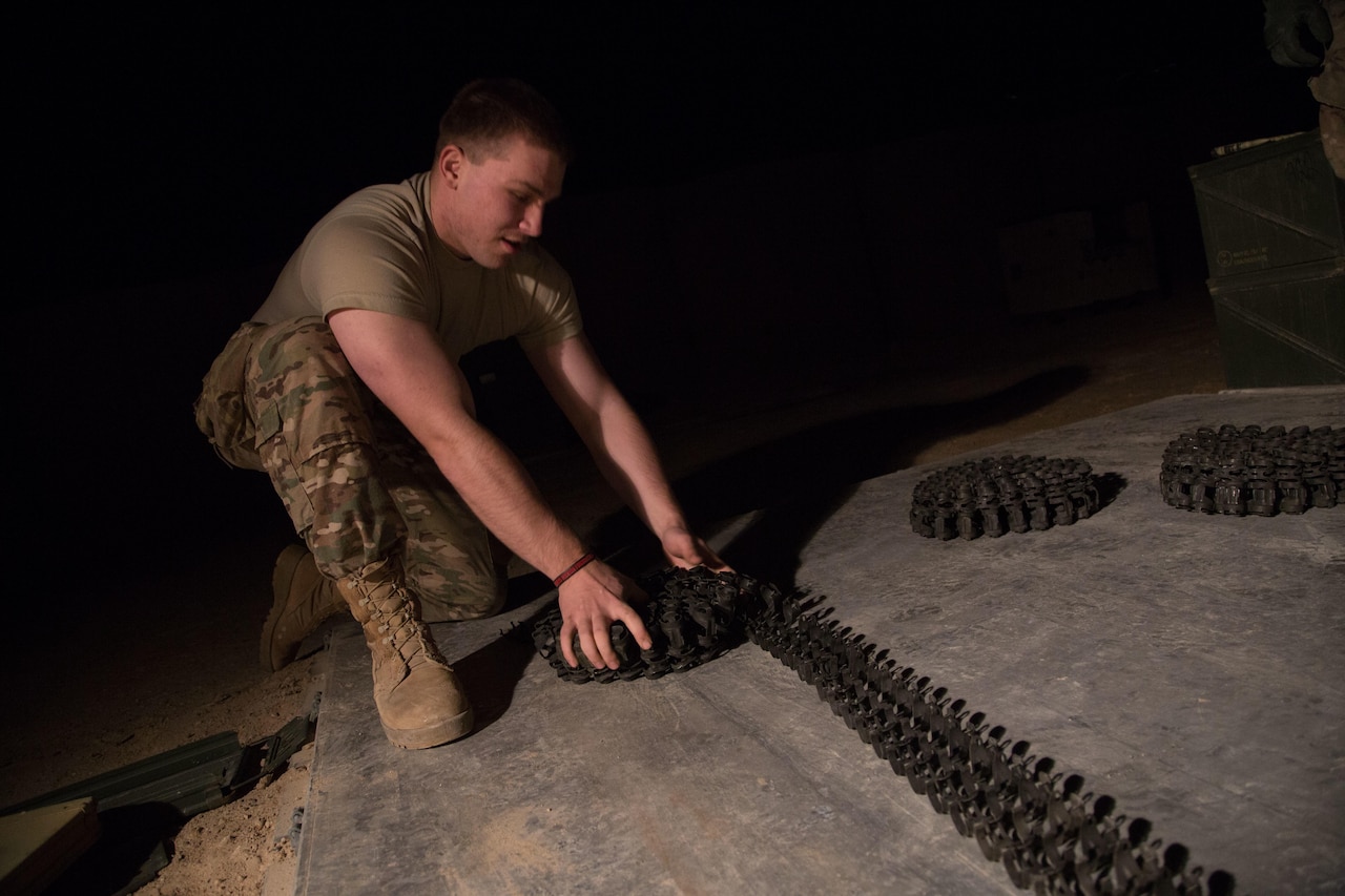 Army Spc. Ivan Celley rolls an ammunition belt for a land–based Phalanx weapon system at Camp Manion, Iraq, Jan 7, 2017. Celley is assigned to Bravo Battery, 5th Battalion, 5th Air Defense Artillery Regiment, The Phalanx is a rapid-fire, computer-controlled, radar-guided gun system designed to defeat anti-ship missiles and other close-in air and surface threats. Army photo by Spc. Christopher Brecht