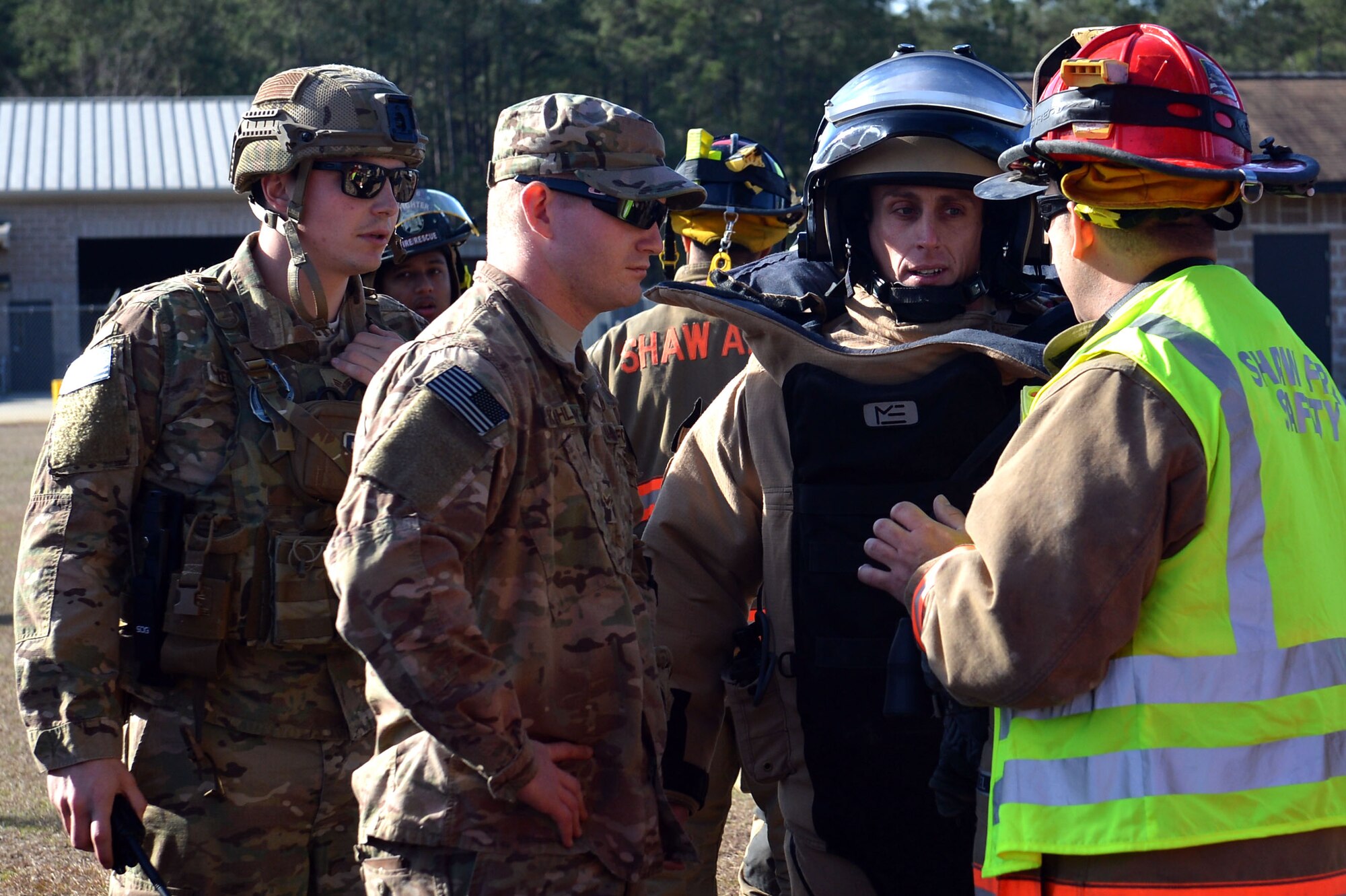U.S. Airmen assigned to the 20th Civil Engineer Squadron fire department and 20th CES explosive ordnance disposal flight discuss a plan of action before participating in a joint hazardous material training at Shaw Air Force Base, S.C., Jan. 19, 2017. The Airmen handled a scenario where an overturned truck spilled simulated chemicals into the environment, caused casualties, and had a possible explosive device in the vicinity. (U.S. Air Force photo by Airman 1st Class Christopher Maldonado)