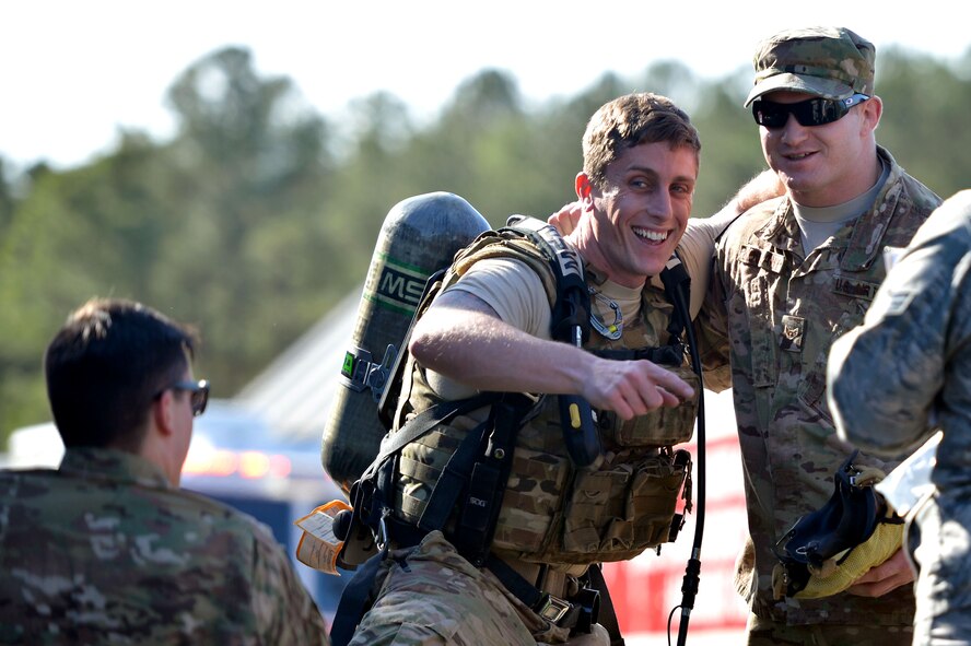 U.S. Air Force Airman 1st Class Tyler Kochlany, 20th Civil Engineer Squadron explosive ordnance disposal (EOD) technician, right, assists Staff Sgt. Andrew Wright, 20th CES EOD technician, center, as he puts on a portable oxygen tank at Shaw Air Force Base, S.C., Jan. 19, 2017. Airmen participating in the joint hazardous material training (HAZMAT) were required to don proper protective gear, to include gloves, boots and a HAZMAT suit. (U.S. Air Force photo by Airman 1st Class Christopher Maldonado)