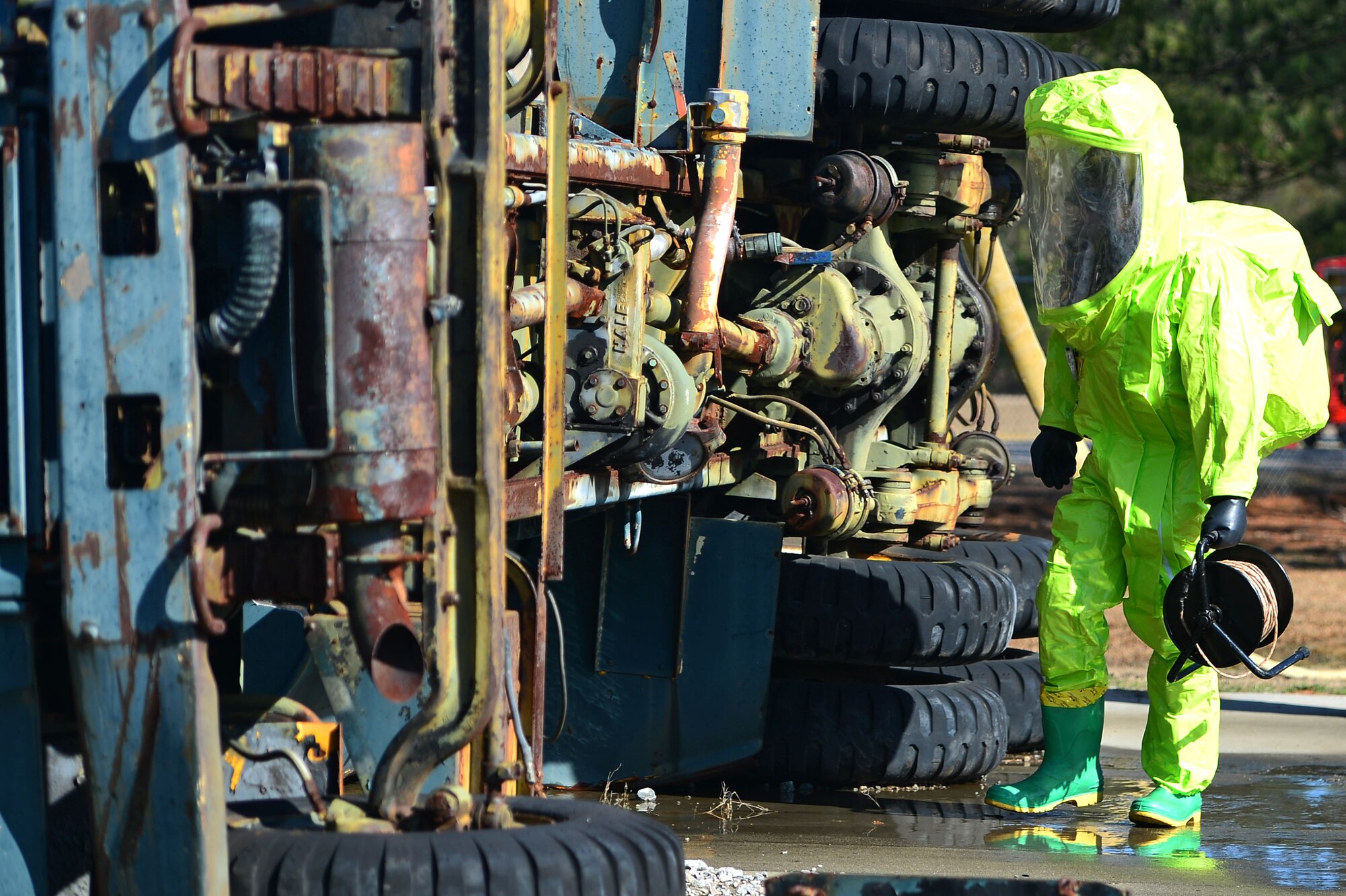 U.S. Air Force Staff Sgt. Andrew Wright, 20th Civil Engineer Squadron explosive ordnance disposal (EOD) technician, inspects a simulated chemical spill site for explosives during a hazardous material training at Shaw Air Force Base, S.C., Jan. 19, 2017. Airmen assigned to the 20th CES EOD flight were tasked with examining the site for explosives using a medium-sized robot followed by an in-person inspection to clear the scene for Airmen from the 20th CES fire department and emergency management flight and 20th Aerospace Medicine Squadron bioenvironmental flight. (U.S. Air Force photo by Airman 1st Class Christopher Maldonado)