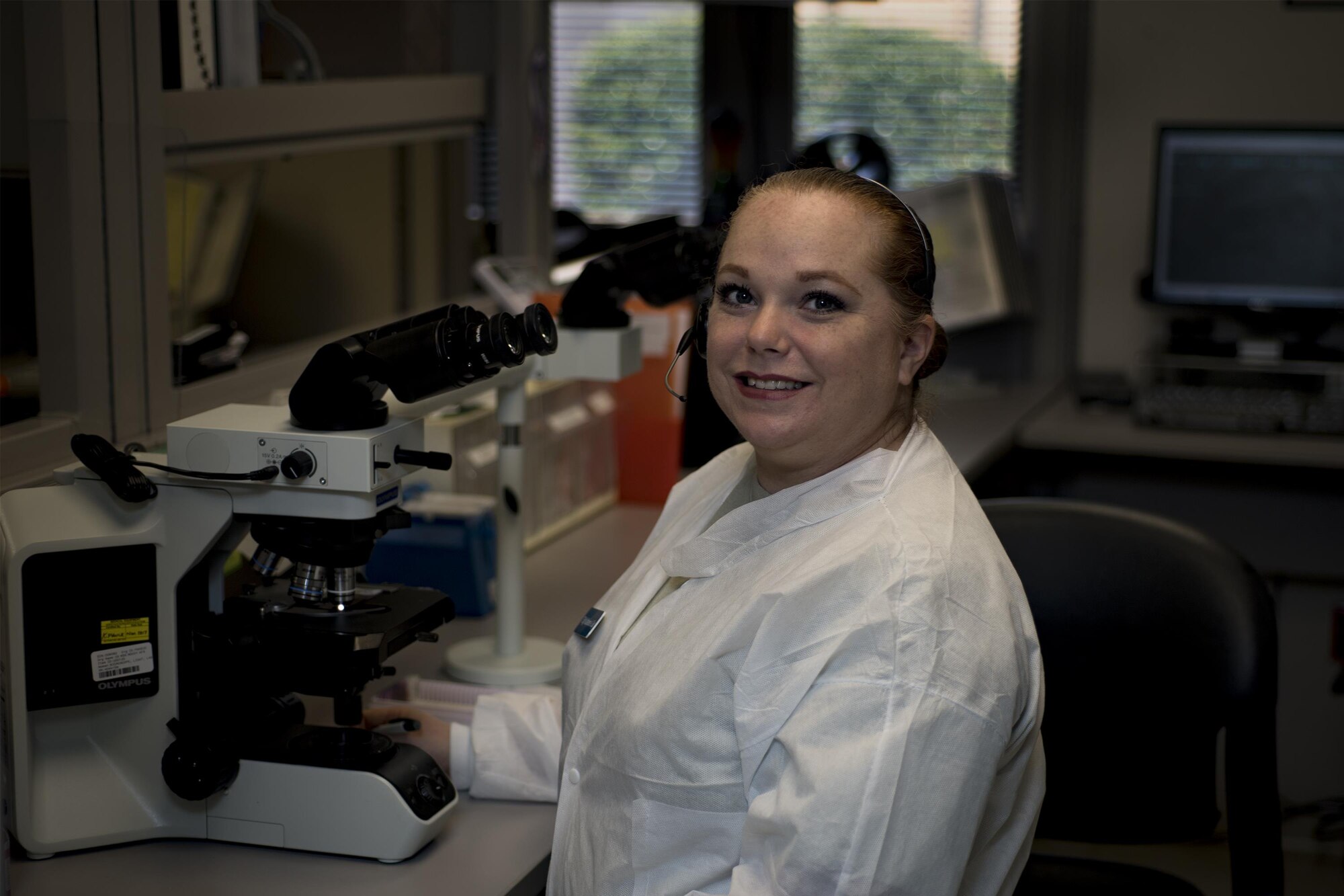 Tech Sgt. Katherine Gay, 23d Medical Support Squadron medical laboratory technician, poses for a photo next to a microscope, Jan. 19, 2016, at Moody Air Force Base, Ga. Biomedical Laboratory members perform analyses of biological materials in hospital, environmental, occupational, epidemiological, toxicological, or research and development laboratories. In the Air Force, there are currently 176 active duty, 25 Air Force reservist and 11 Air National Guard biomedical laboratory officers. (U.S. Air Force photo by Airman 1st Class Daniel Snider)