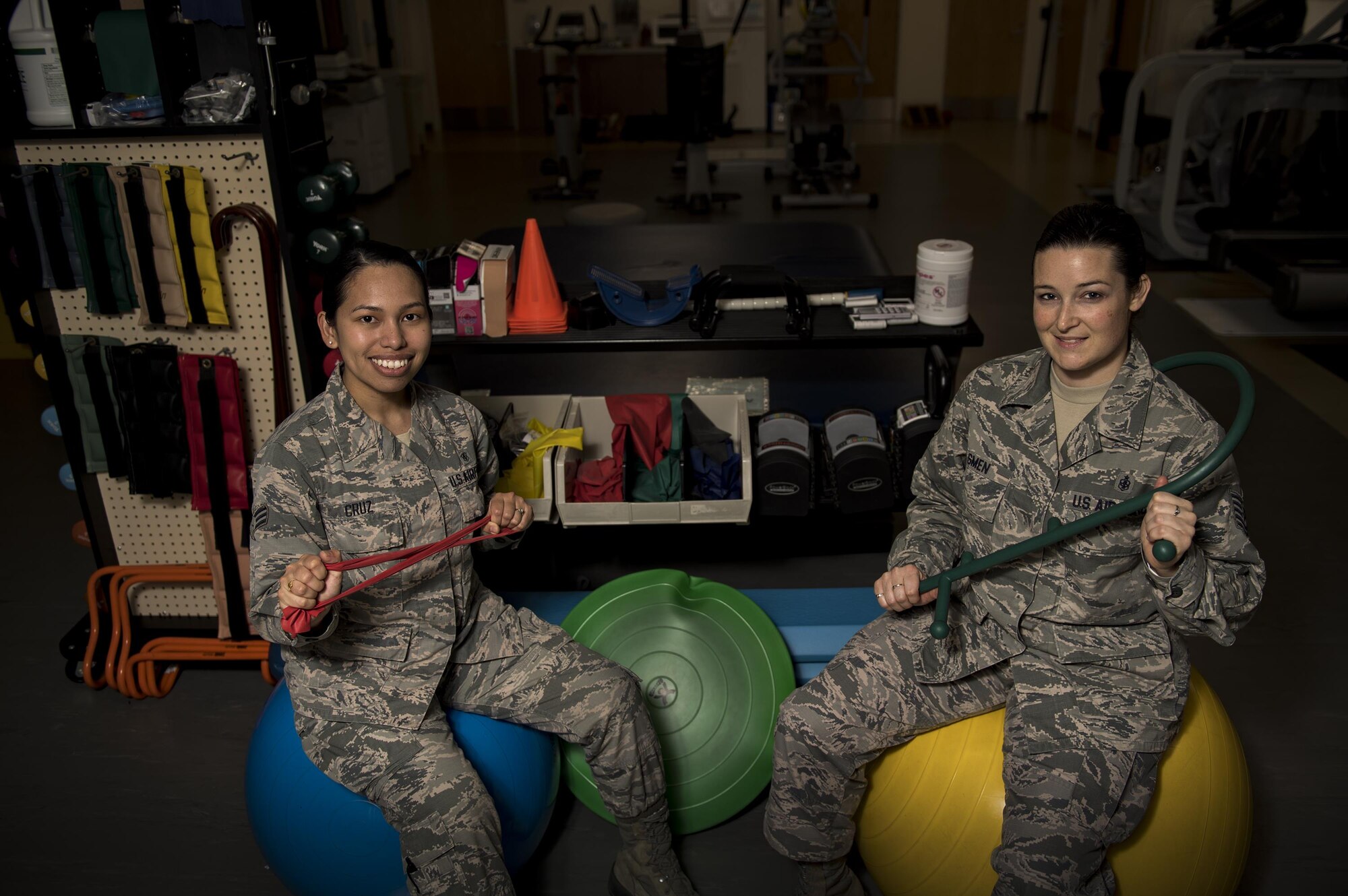 Senior Airman Gresil Cruz, 23d Medical Operations Squadron physical therapy technician, left, and Tech Sgt. Rebecca Smen, 23d MDOS NCO in charge of physical therapy, pose for a photo with various items used in physical therapy, Jan. 19, 2016, at Moody Air Force Base, Ga. Physical therapists evaluate, diagnose, and treat disabilities and limitations to restore physical function and mobility to Airmen and their families. In the Air Force, there are currently 142 active duty, 20 Air Force reservist and seven Air National Guard physical therapists. (U.S. Air Force photo by Airman 1st Class Daniel Snider)