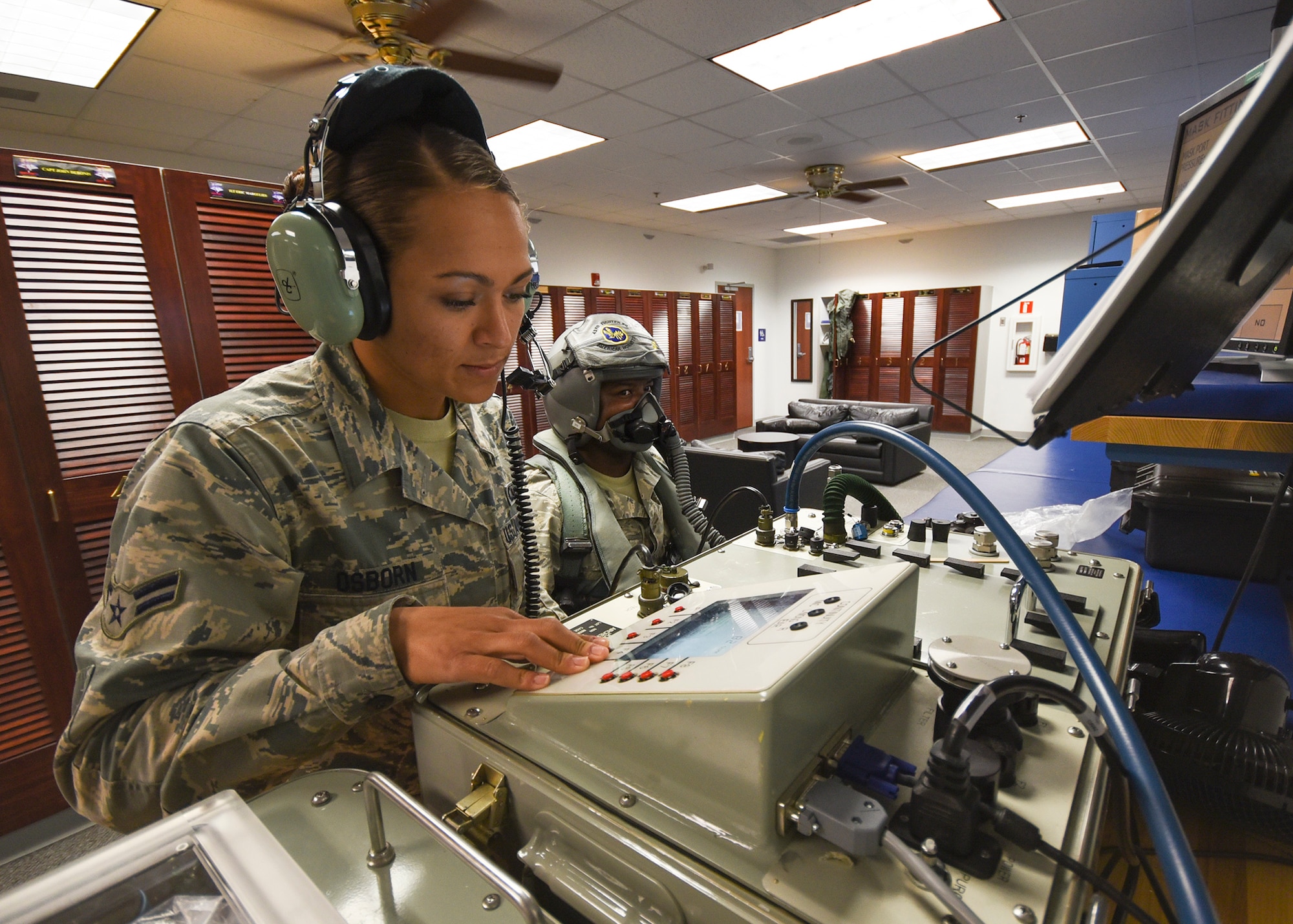 U.S. Air Force Airman 1st Class Cortney Osborn, 325th Operations Support Squadron aircrew flight equipment journeyman, conducts a mask test on Tech. Sgt. Christopher Battle, 325th OSS AFE NCO in-charge, at Tyndall Air Force Base, Fla., Jan. 19, 2017. The shop supports the 325th Fighter Wing mission by conducting extensive inspections on mission critical lifesaving equipment, such as pilot helmets and oxygen masks, anti-gravity suits, advanced concept ejection seats and survival kits. (U.S. Air Force photo by Senior Airman Dustin Mullen/Released) 