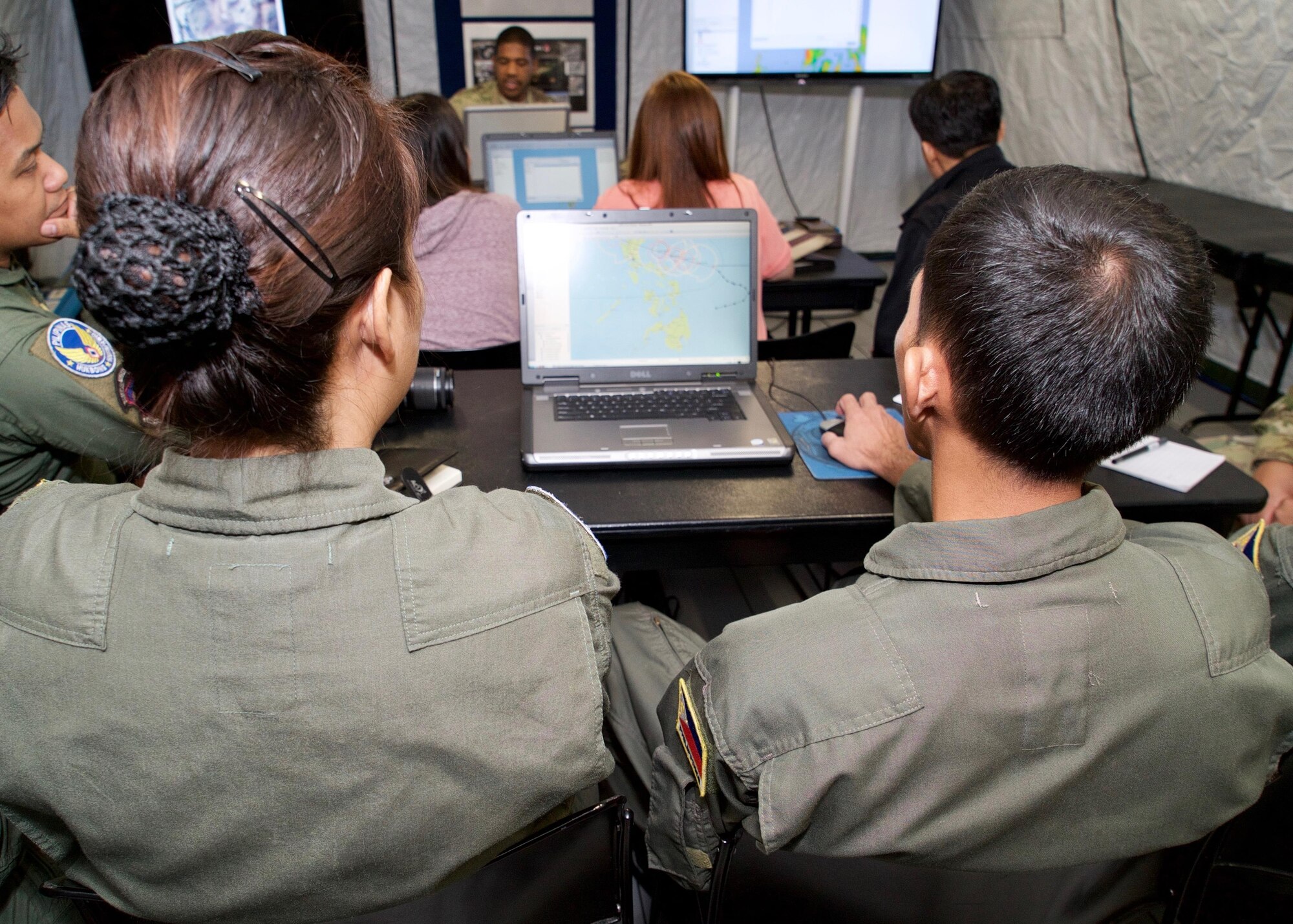 Philippine Air Force aerial reconnaissance photographers, Sgt. Charisma Navarro (left) and Tech. Sgt. Primitivio Cedi Jr. (right), review geospatial map layers during a software demonstration, Clark Air Base, Philippines, Jan. 20, 2017. Navarro and Cedi are members of an ongoing Subject Matter Expert Exchange (SMEE) between Philippine and U.S. Air Forces. The SMEE concentrates on enhancing the military-to-military relationship and readiness of both nations when conducting Humanitarian Assistance and Disaster Relief operaions common in the Asia-Pacific. (U.S. Air Force photo by Tech. Sgt. James Stewart/Released)