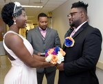 Connie (left) and Albert (right) Ross recite their 10-year vow renewal Jan. 19 in the exact same spot where they first met at the Brooke Army Medical Center 12 years ago. Retired Army Staff Sgt. William Watson (center) was the bride’s “Battle Buddy” and officiated the ceremony.