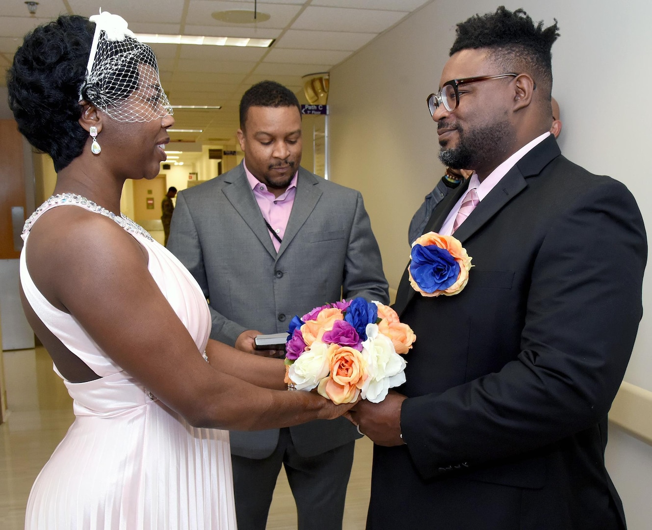 Connie (left) and Albert (right) Ross recite their 10-year vow renewal Jan. 19 in the exact same spot where they first met at the Brooke Army Medical Center 12 years ago. Retired Army Staff Sgt. William Watson (center) was the bride’s “Battle Buddy” and officiated the ceremony.