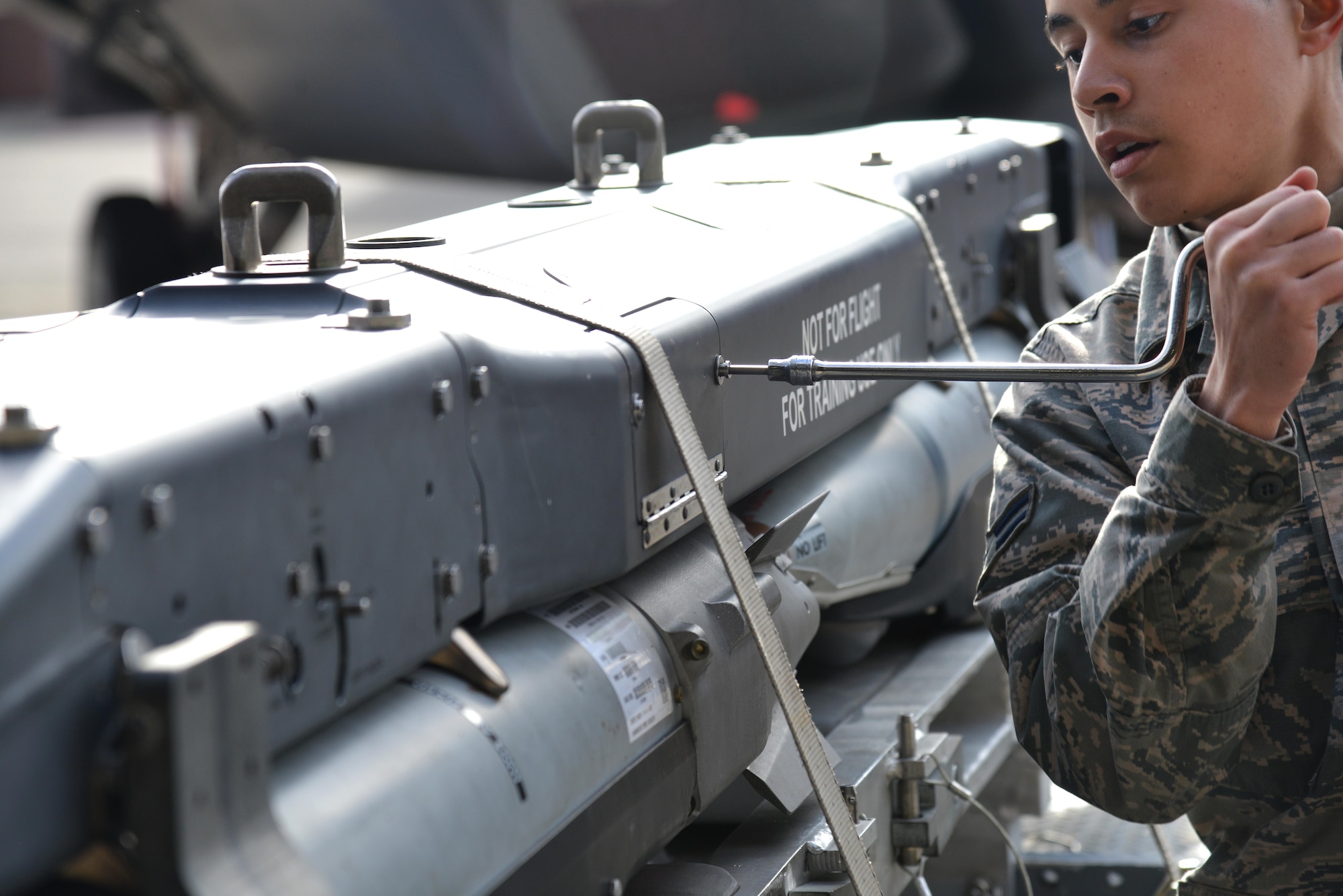 U.S. Air Force Airman 1st Class Julian Lopez, 94th Aircraft Maintenance Unit weapons load crew member, checks a preloaded BRU-61 during the 1st Maintenance Squadron Weapons Load Crew of the Year competition at Joint Base Langley-Eustis, Va., Jan. 13, 2017. The competition is held every year and allows load crews from aircraft maintenance units to showcase their skills and abilities while loading the aircraft with munitions. (U.S. Air Force photo by Airman 1st Class Tristan Biese)