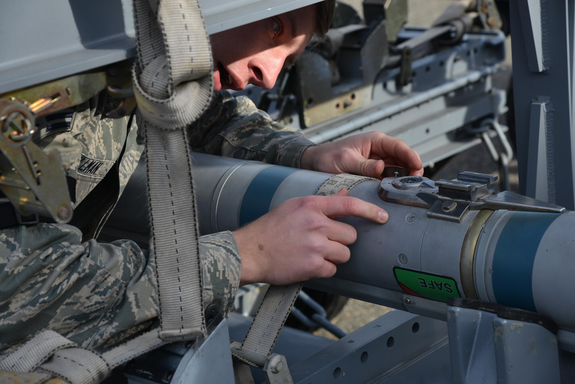 U.S. Air Force Senior Airman James Stillman, 27th Aircraft Maintenance Unit weapons load crew member, checks an AIM-9X missile during the 1st Maintenance Squadron Weapons Load Crew of the Year competition at Joint Base Langley-Eustis, Va., Jan. 13, 2017. The weapons load crews worked in three-person teams to inspect and load munitions onto an F-22 Raptor in a timely and accurate manner. (U.S. Air Force photo by Airman 1st Class Tristan Biese)