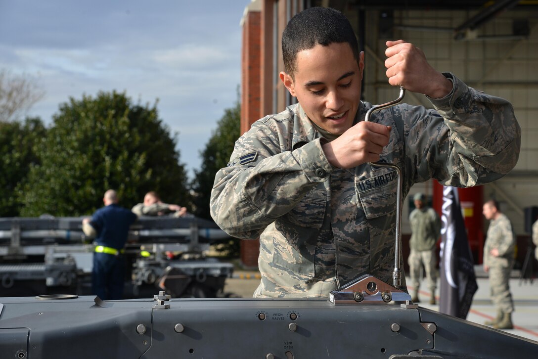 U.S. Air Force Airman 1st Class Julian Lopez, 94th Aircraft Maintenance Unit weapons load crew member, checks a preloaded BRU-61 during the 1st Maintenance Squadron Weapons Load Crew of the Year competition at Joint Base Langley-Eustis, Va., Jan. 13, 2017. During the competition, both teams were tasked to load one AIM-9X missile and one preloaded BRU-61 with four GBU-39 missiles onto an F-22 Raptor in a timely and accurate manner. (U.S. Air Force photo by Airman 1st Class Tristan Biese)