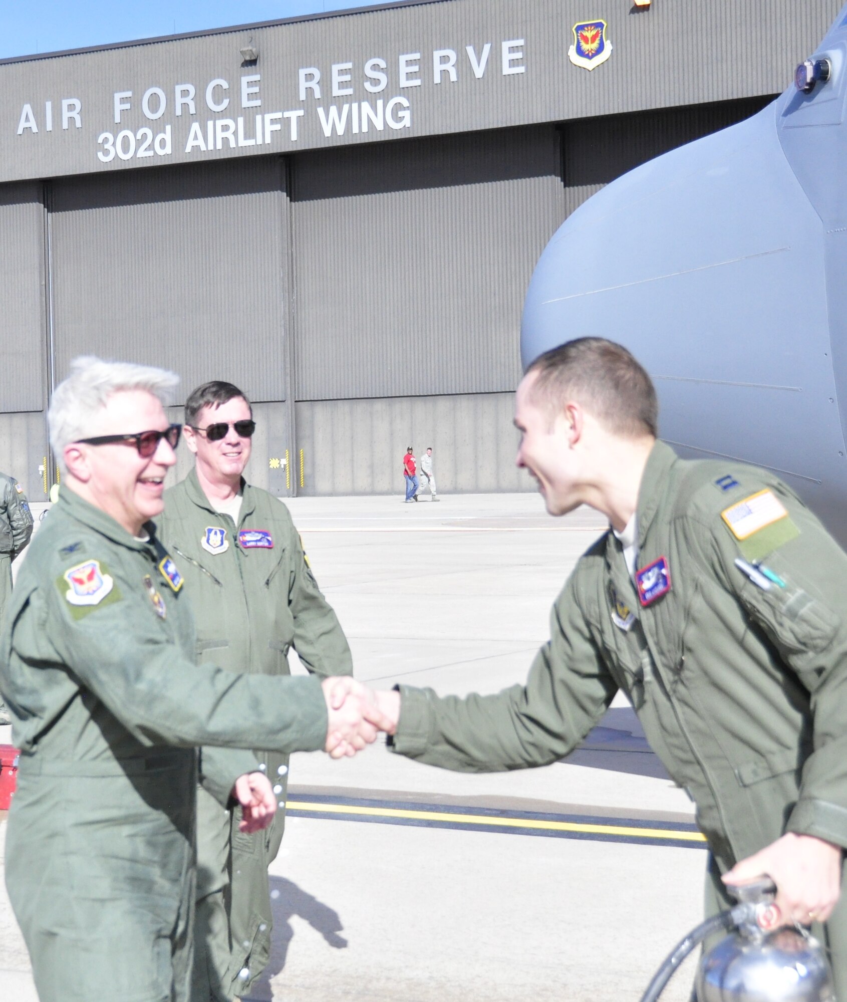 PETERSON AIR FORCE BASE, Colo. – Capt. Erik Anonsen, right, congratulates Col. Erich Novak following the colonel’s fini flight with the Air Force Reserve Command’s 302nd Airlift Wing Jan. 18, 2017 here. Novak, the 302nd AW vice commander and aircraft command pilot with more than 9,000 flight hours, accepted a position as mobilization assistant to the commander, 20th Air Force, F.E. Warren Air Force Base, Wyo. Novak was assigned to the Reserve wing for nearly two years. (U.S. Air Force photo/Daniel Butterfield)