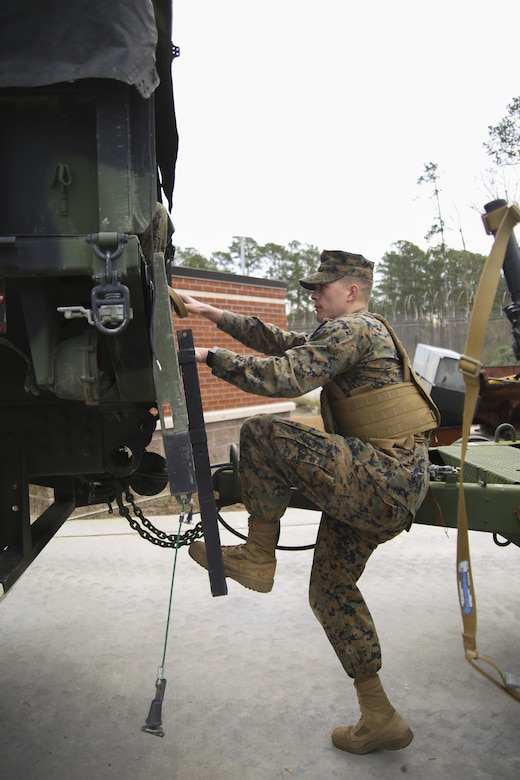 A Marine climbs into a tactical vehicle during a Strategic Mobility Exercise aboard Marine Corps Air Station Cherry Point, N.C., Jan. 20, 2017. Marines assigned to Marine Air Support Squadron 1, Marine Air Control Group 28, 2nd Marine Aircraft Wing simulated troop movement in response to a limited/ no-notice mock deployment of a Direct Support Center with extensions in support of overseas contingency operations. Marines must maintain their ability to react effectively and in a timely matter when called upon to support operations anywhere in the world.  (U.S. Marine Corps photo by Sgt. N.W. Huertas/ Released)