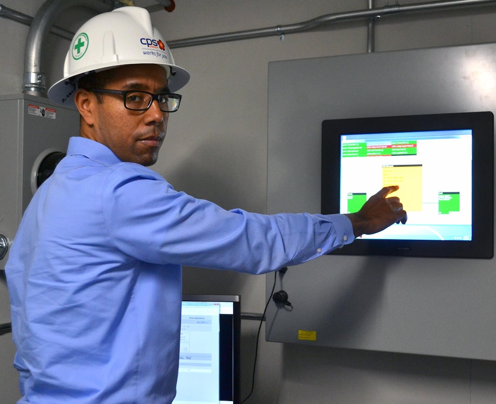 James Boston III, CPS Energy manager of market intelligence, shows how one of components in the battery energy storage system works at the microgrid test site at the JBSA-Fort Sam Houston Campbell Memorial Library on Jan. 13. Powered by solar energy, the microgrid has the capability of producing energy for the library while being disconnected from the electric grid.