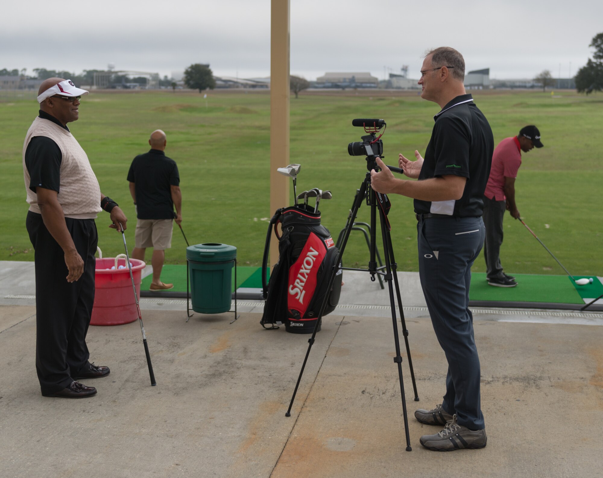 Richard Beyer, Power Tee chief operating officer, interviews Daniel Gillus, 81st Force Support Squadron Bay Breeze golf pro, during the Power Tees driving range grand opening Jan. 20, 2017, on Keesler Air Force Base, Miss. The Power Tee is an automated ball teeing system aimed to help regular golfers improve their game and swing and to attract young golfers to the course. (U.S. Air Force photo by Andre’ Askew)   