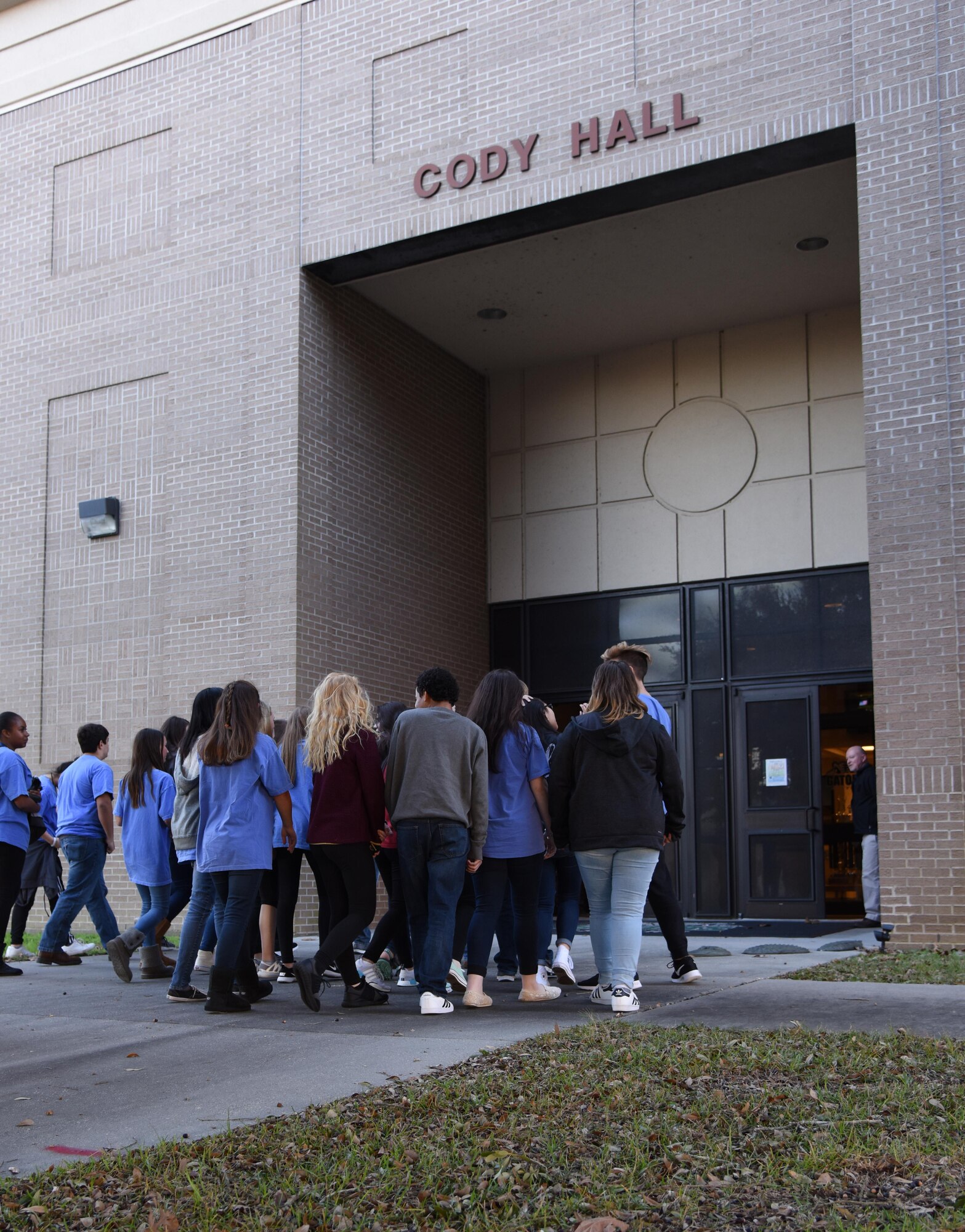 Local high school freshmen enter Cody Hall during the Biloxi Chamber of Commerce Gulf Coast Junior Leadership Tour Jan. 24, 2017, on Keesler Air Force Base, Miss. The group’s objective is to produce students of outstanding character, while teaching them about community needs what it takes to become a leader in today’s society. The visit included a 334th Training Squadron air traffic control course overview, military training leader briefing and a dorm tour. (U.S. Air Force photo by Kemberly Groue)