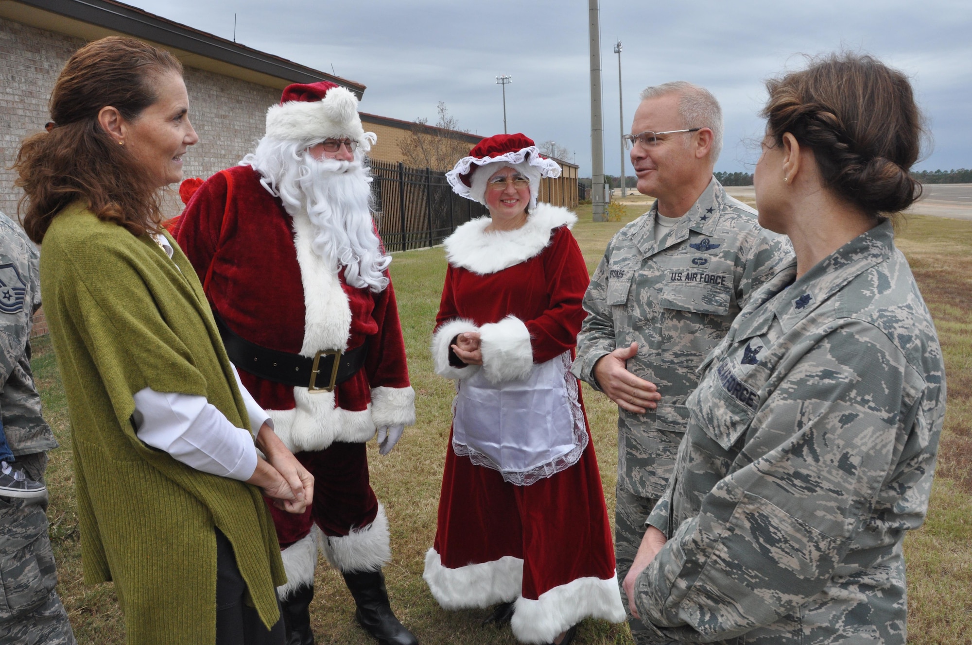Santa and Mrs. Claus talk with Sandy Stokes (Left) wife of 22nd Air Force Commanding General, Maj. Gen. John Stokes, and Lt. Col. Nancy Stephenson (Right), executive officer of the 908th Airlift Wing during a visit to Maxwell Air Force Base Dec. 3. The Stokes were visiting the their old unit, the 908th before the winter holidays. (U.S. Air Force photo by Bradley J. Clark)