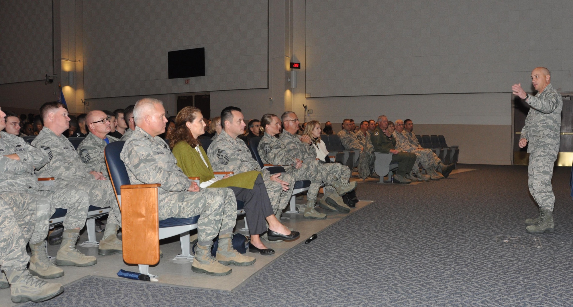 Commanding General of the 22nd Air Force, Maj. Gen. John Stokes listens to Col. David Condit, Commander of the 908th Airlift Wing address the members of the wing during a Commander's Call at Polifka Auditorium Dec. 3. Stokes used to be a member of the 908th and came back to visit with the unit before the winter holidays. (U.S. Air Force photo by Bradley J. Clark)